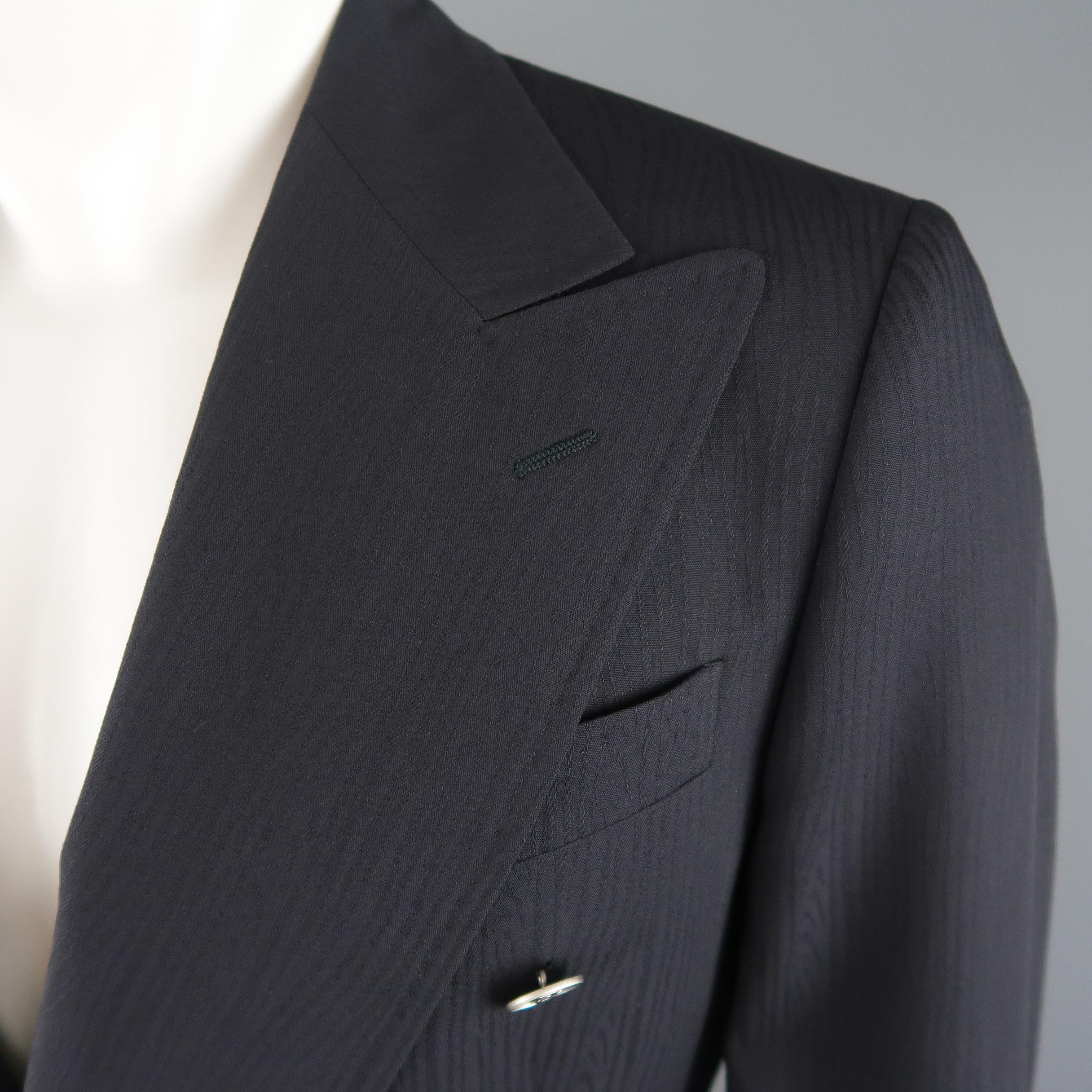 DOLCE & GABBANA sport coat comes in moire wool with a peak lapel, double breasted closure, matte silver tone metal buttons with gold tone DG logos, and double vented back. Made in Italy.
 
Excellent Pre-Owned Condition.
Marked: IT 38
