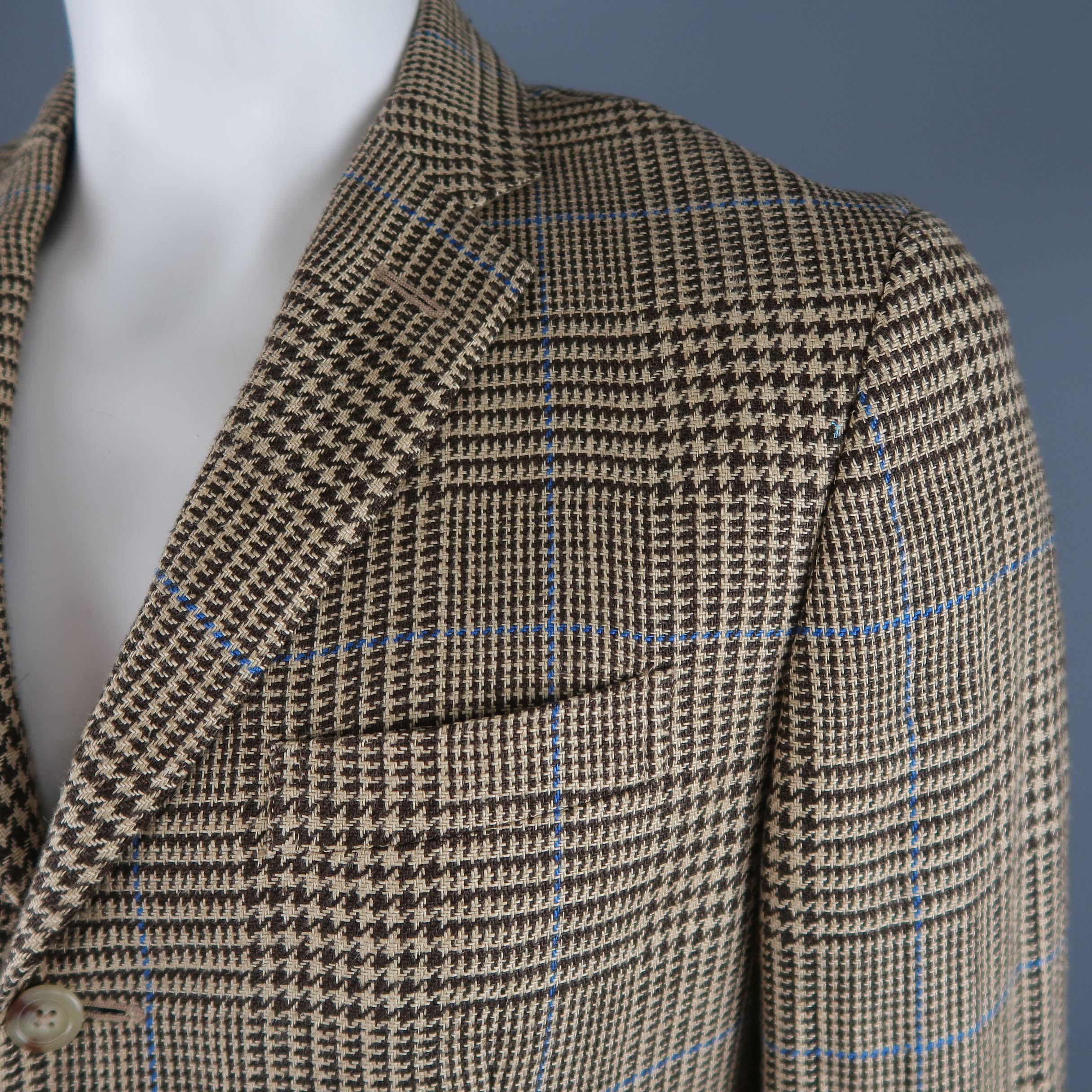 POLO RALPH LAUREN sport coat comes in beige and brown glenplaid with all over blue windowpane pattern woven flax material with a notch lapel, three button single breasted closure, and flap pockets. Made in Italy. Retail price $1,800.00.
 
Excellent