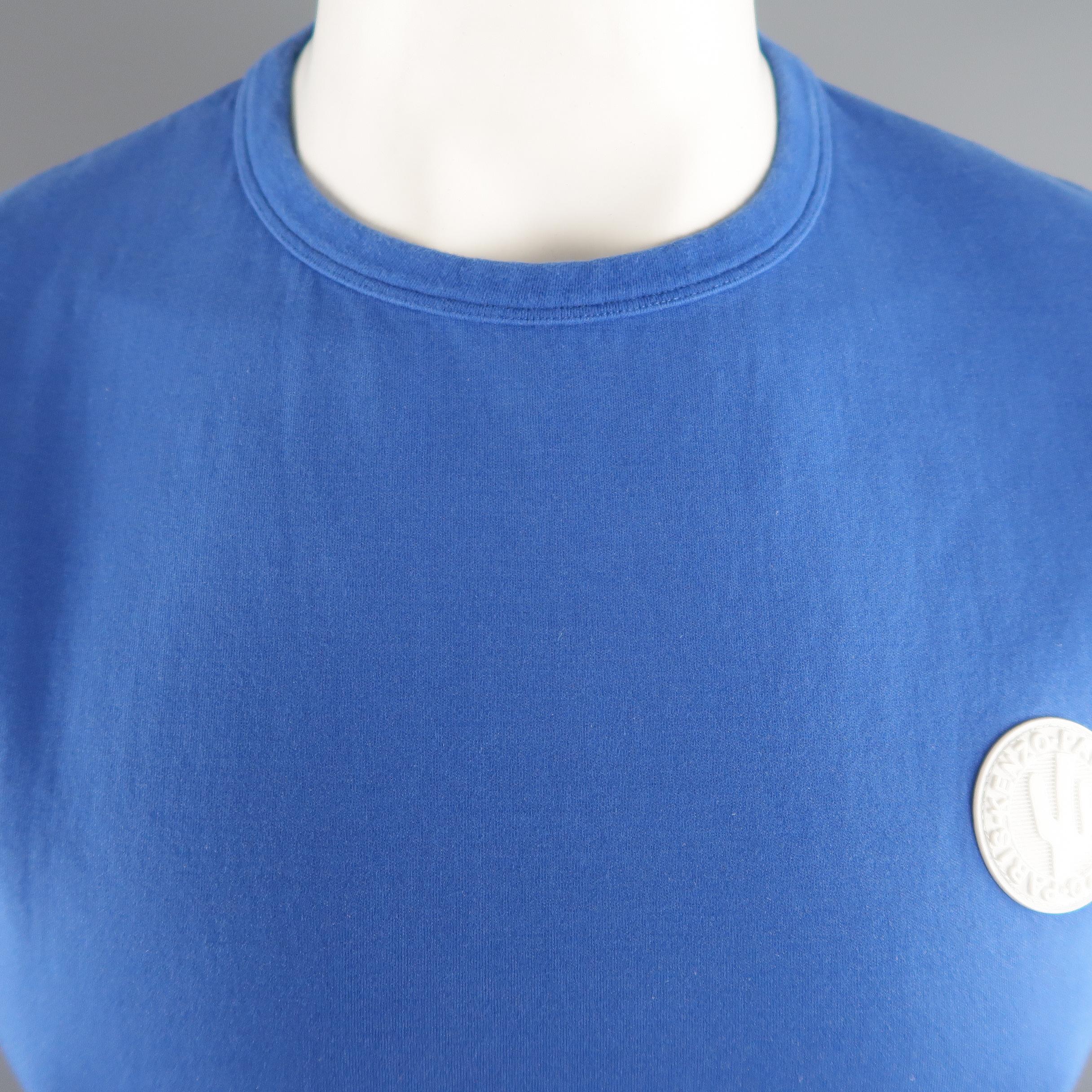 KENZO T-shirt comes in blue solid tone in cotton / spandex material, with a white logo patch and a crewneck. Minor wear.
 
Good Pre-Owned Condition.
Marked: M
 
Measurements:
 
Shoulder:  17.5  in.
Chest:  43  in.
Sleeve: 9.5  in.
Length:  26.5   in.