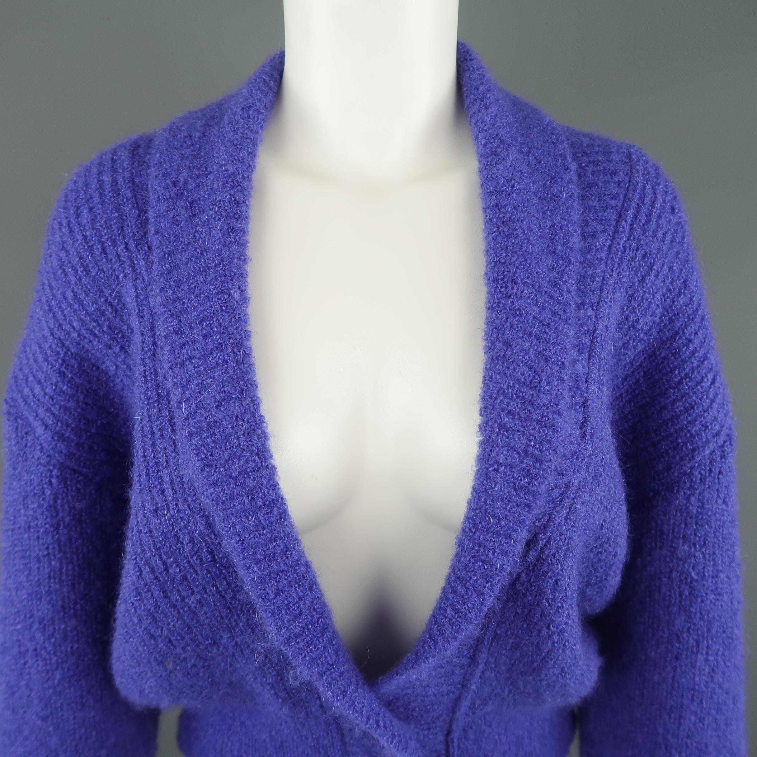 Vintage JAEGER cardigan comes in a fuzzy purple knit with a deep V shawl collar neckline, drop shoulder sleeves, and cropped hem with two button closure. Made in Great Britain.
 
Excellent Pre-Owned Condition.
Marked: M
 
Measurements:
 
Shoulder: