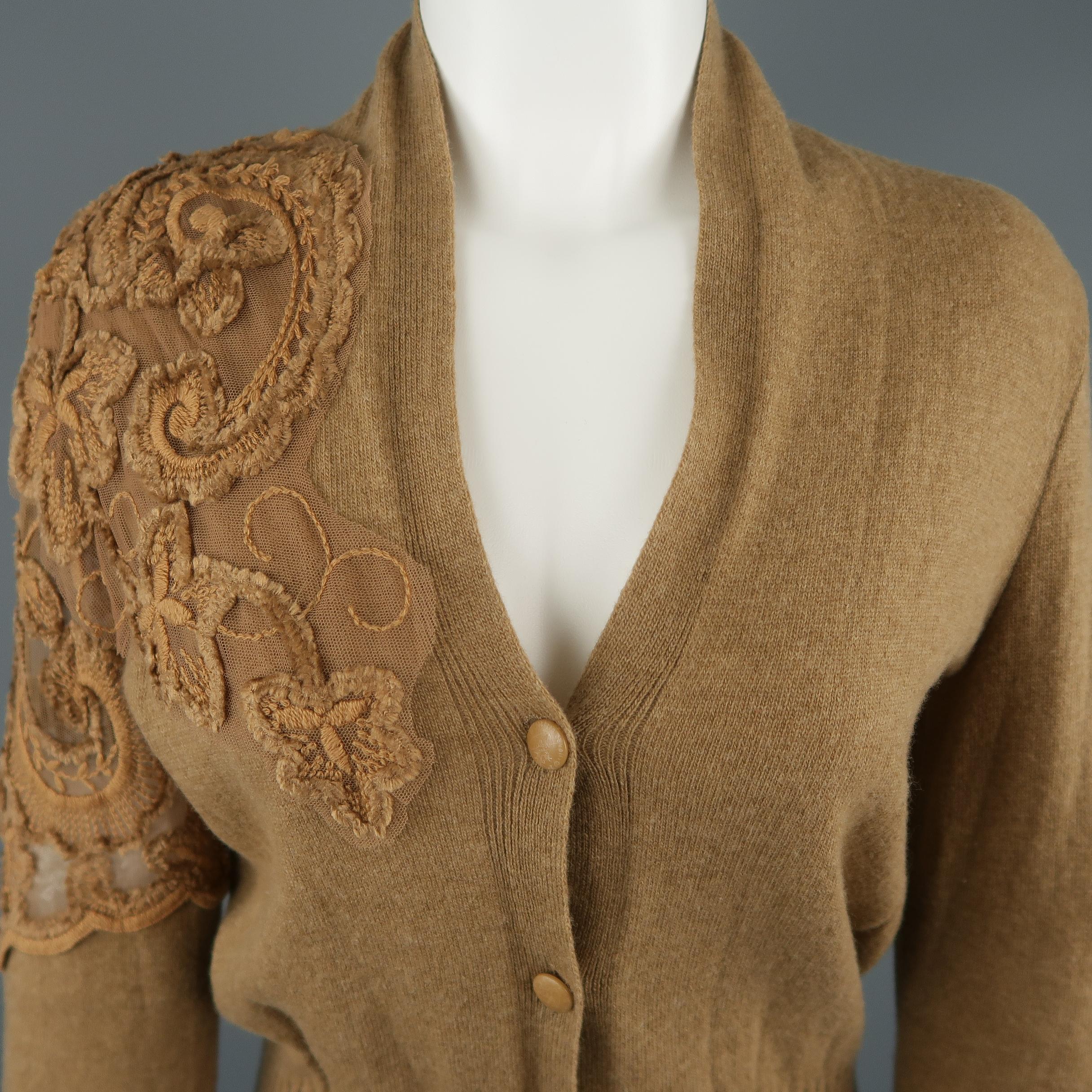 CLASS by ROBERTO CAVALLI cardigan comes in tan wool knit with a V neck, thick ribbed waistband, and asymmetrical floral embroidered lace applique shoulder and sleeve panel. Made in Italy.
 
Excellent Pre-Owned Condition.
Marked: 6
 
Measurements:

