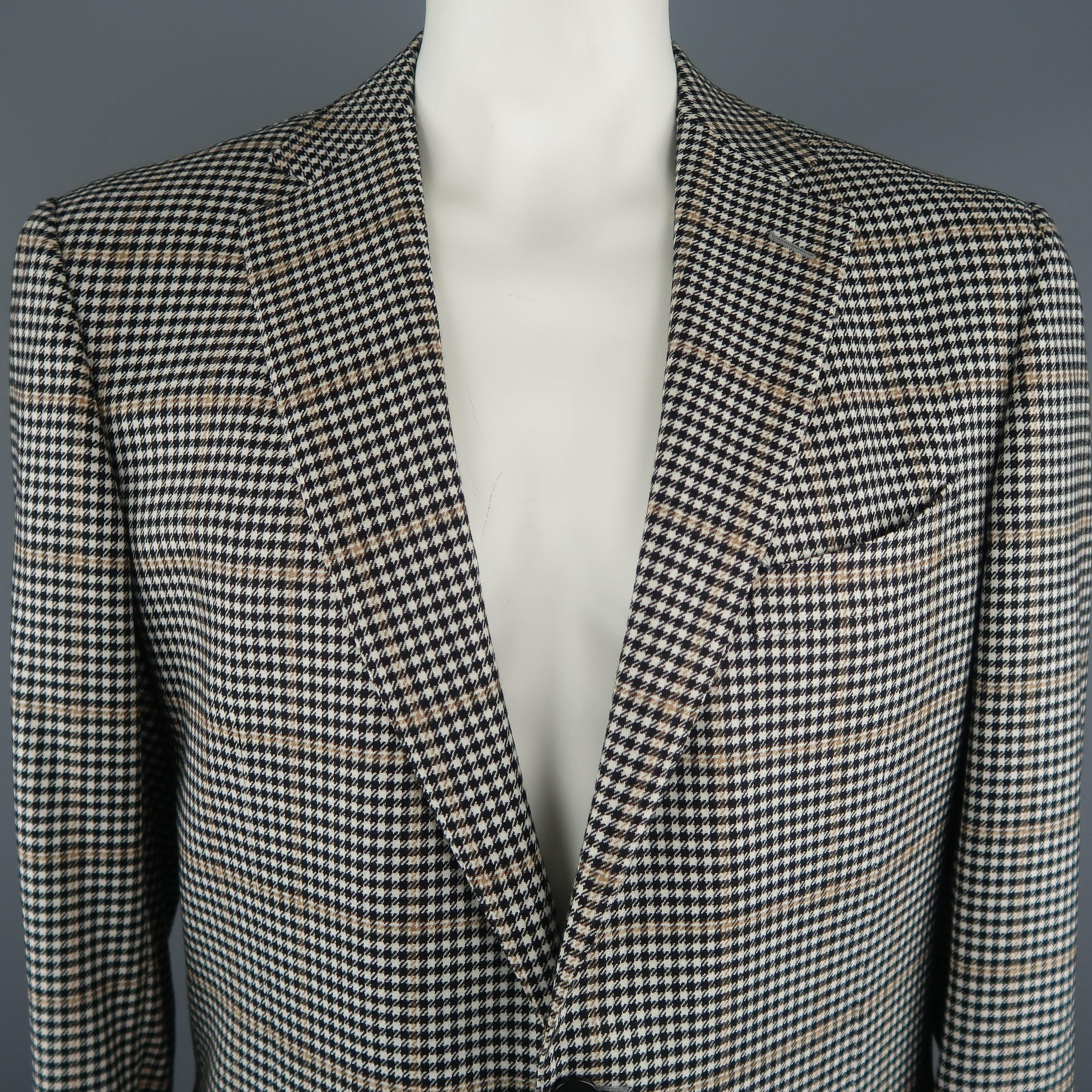 ERMENEGILDO ZEGNA sport coat comes in black and white tones in houndstooth cashmere material, single breasted, with a notch lapel, 2 buttons at closure and slit pockets. Made in Switzerland.
 
Excellent  Pre-Owned Condition.
Marked: 58R
