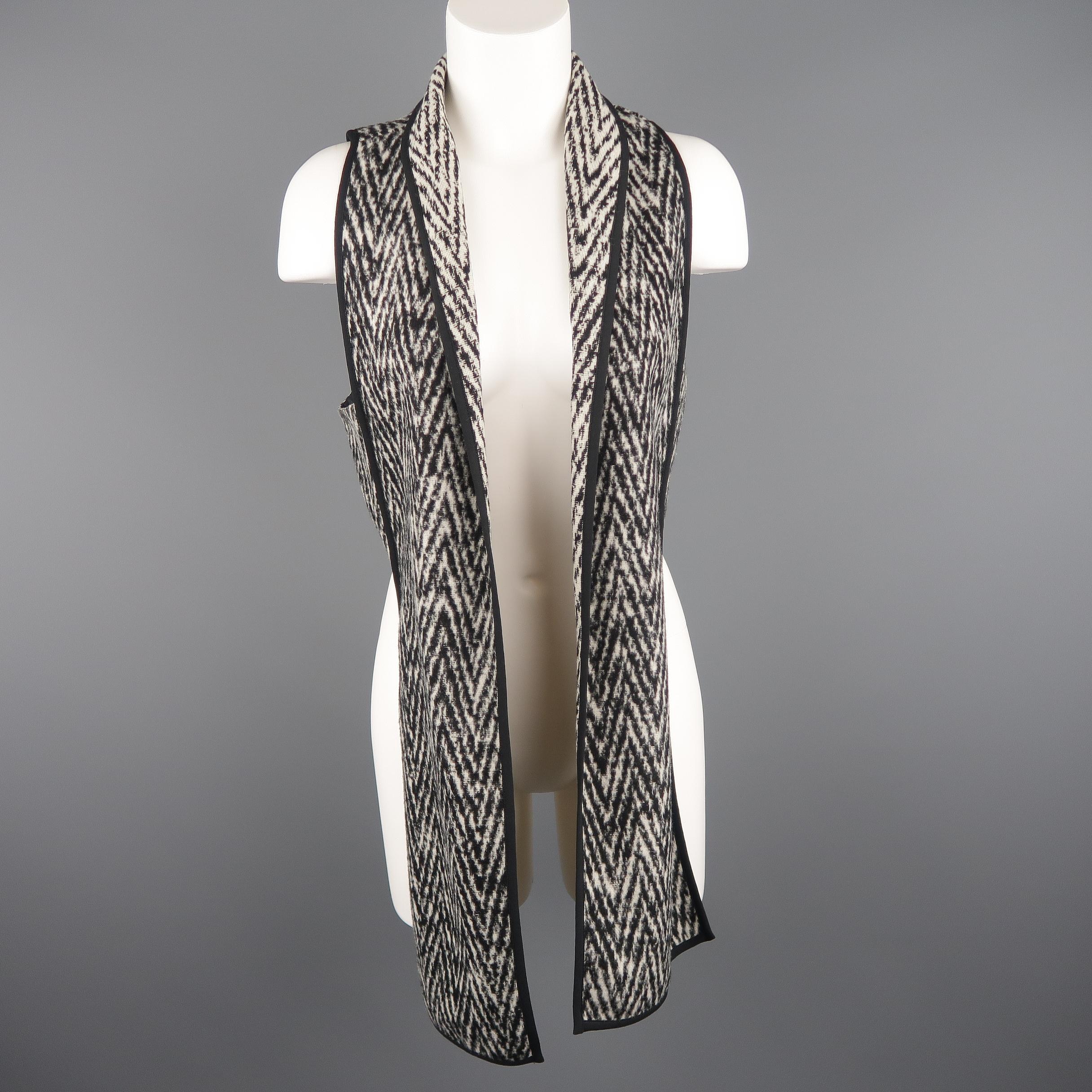 MARISSA WEBB vest comes in a black and beige chevron wool blend with nylon liner, geometric long collar front, and short back.
 
New with Tags.
Marked: S
 
Measurements:
 
Shoulder: 11 in.
Bust: 36 in.
Length: 18 - 33 in.