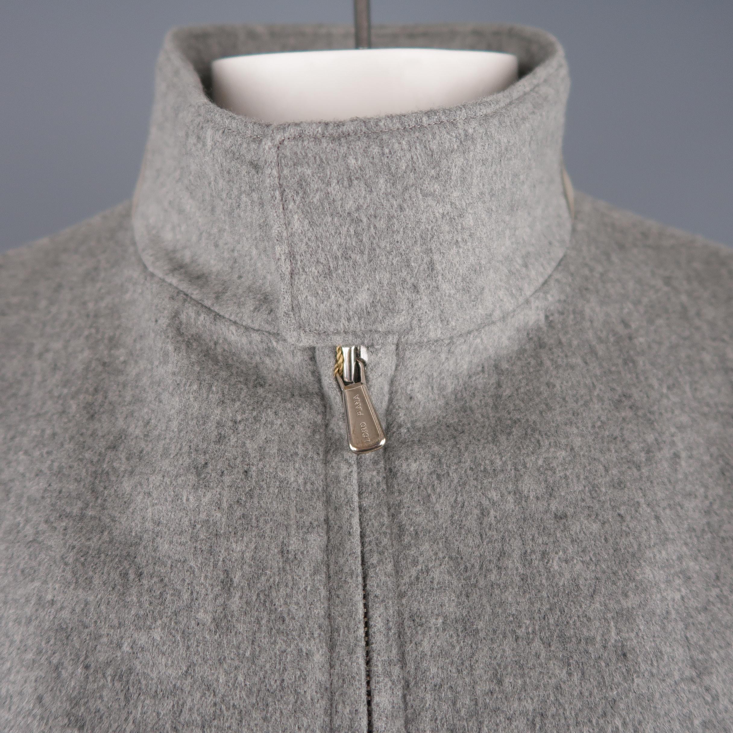 LORO PIANA Storm System bomber jacket comes in light heather gray cashmere with a high collar with suede back, double zip closure, slanted snap flap pockets, and side tabs. Made In Italy. Retail price $ 2,695.00
 
New with Tags.
Marked: L
