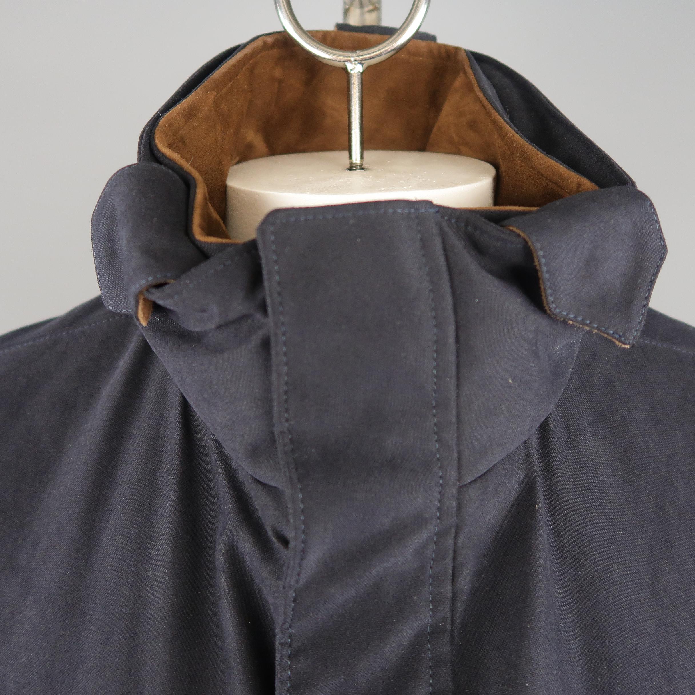 LORO PIANA Storm System jacket comes in navy fabric with a high collar, double zip  front with snap placket, slanted zip pockets, flap pockets, detachable inner collar, and brown suede trim. Made In Italy.
 
New without Tags. Retails: