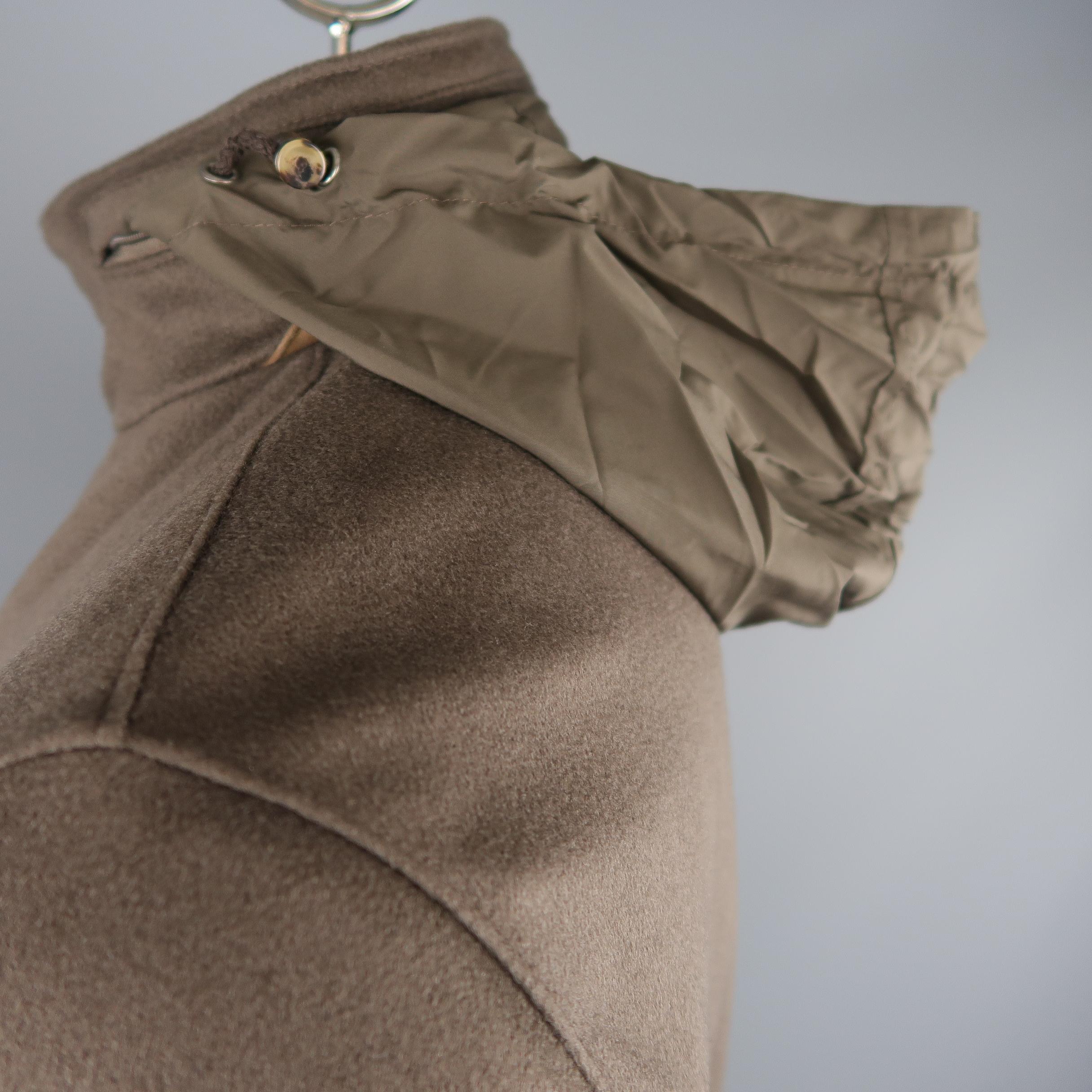 LORO PIANA Storm System jacket comes in brown cashmere with a high, suede trimmed collar with zip out hood, double zip front with hidden snap placket, and flap patch pockets. Made In Italy.
 
New without Tags. Retails: $5,145.00.
Marked: L
