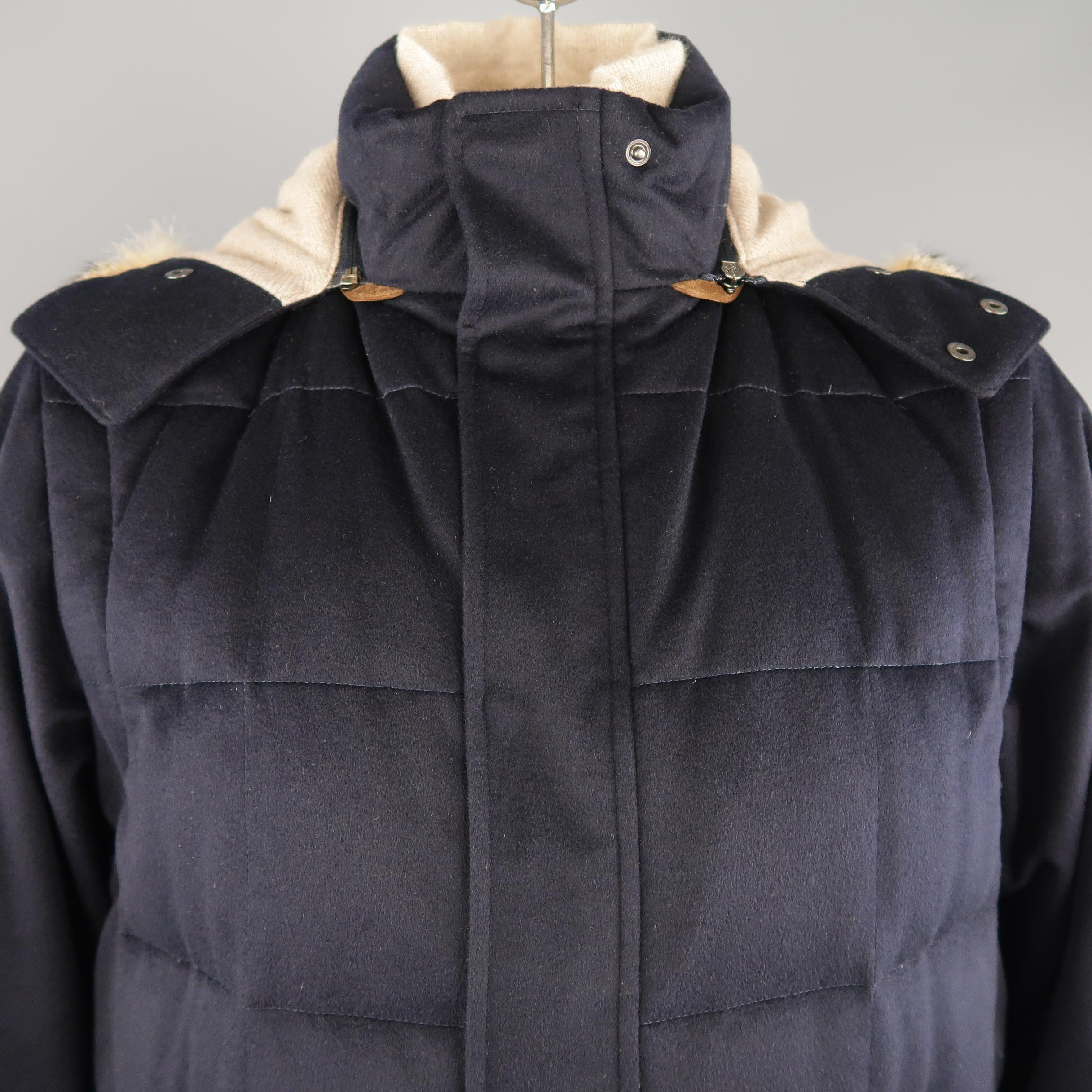 LORO PIANA parka comes in navy down filled navy quilted cashmere with a high collar, hidden snap placket zip closure, slanted pockets, navy suede trim, zip off sleeves, and detachable hood with beige knit liner and fur trim. Made in Italy.    
 
New