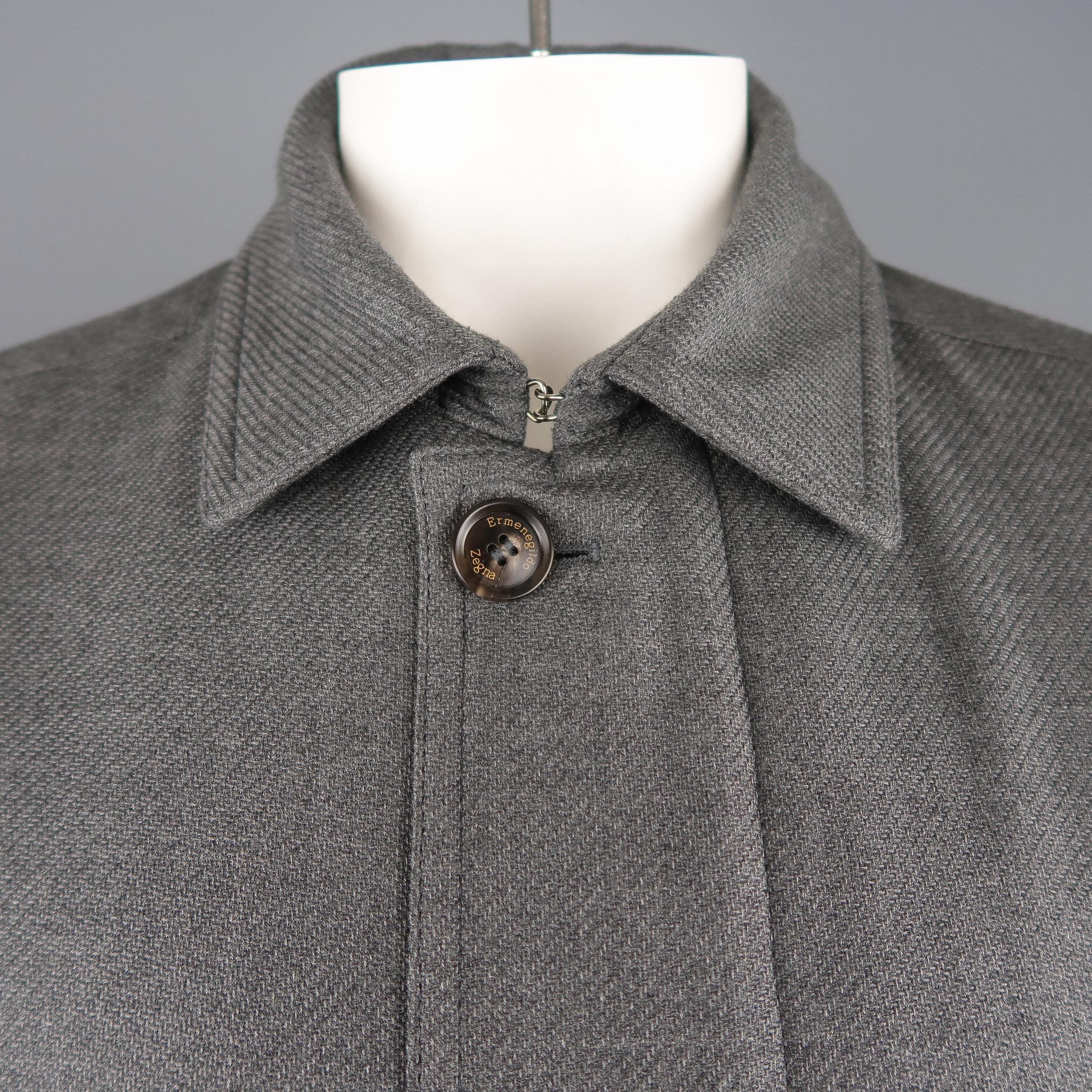 ERMENEGILDO ZEGNA coat comes in medium gray cashmere silk blend fabric with a pointed collar, double zip closure with button placket, double flap patch pockets single zip pocket, and button tab cuffs.
 
New with Tags. Retails: $2,820.00
Marked: IT