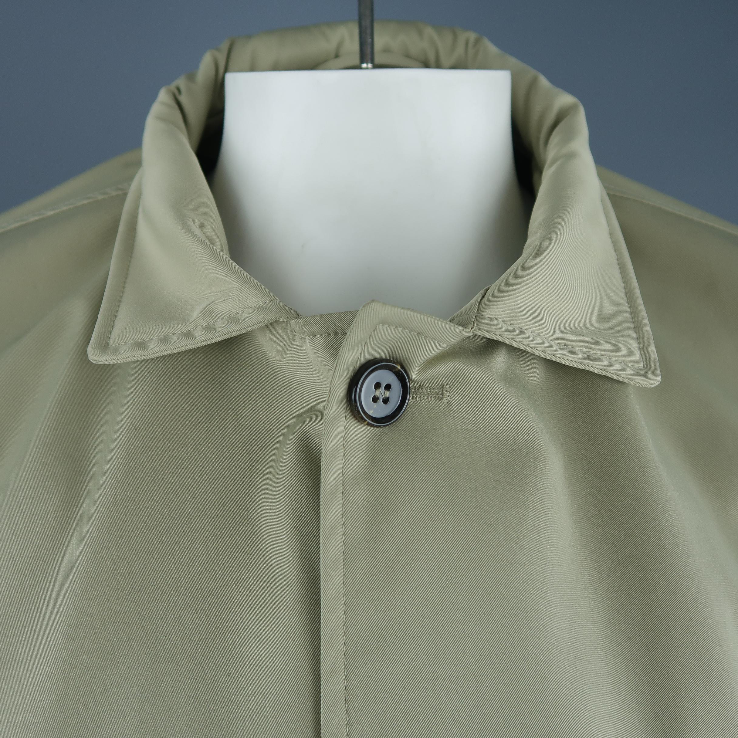 EREDI PISANO raincoat comes in khaki twill with a optional zip hood collar, button up front, slanted pockets, button tab cuffs, and detachable zip pout vest liner. Made in Italy.
 
New with Tags. Retails: $1200.
Marked: (no size)
 
Measurements:
