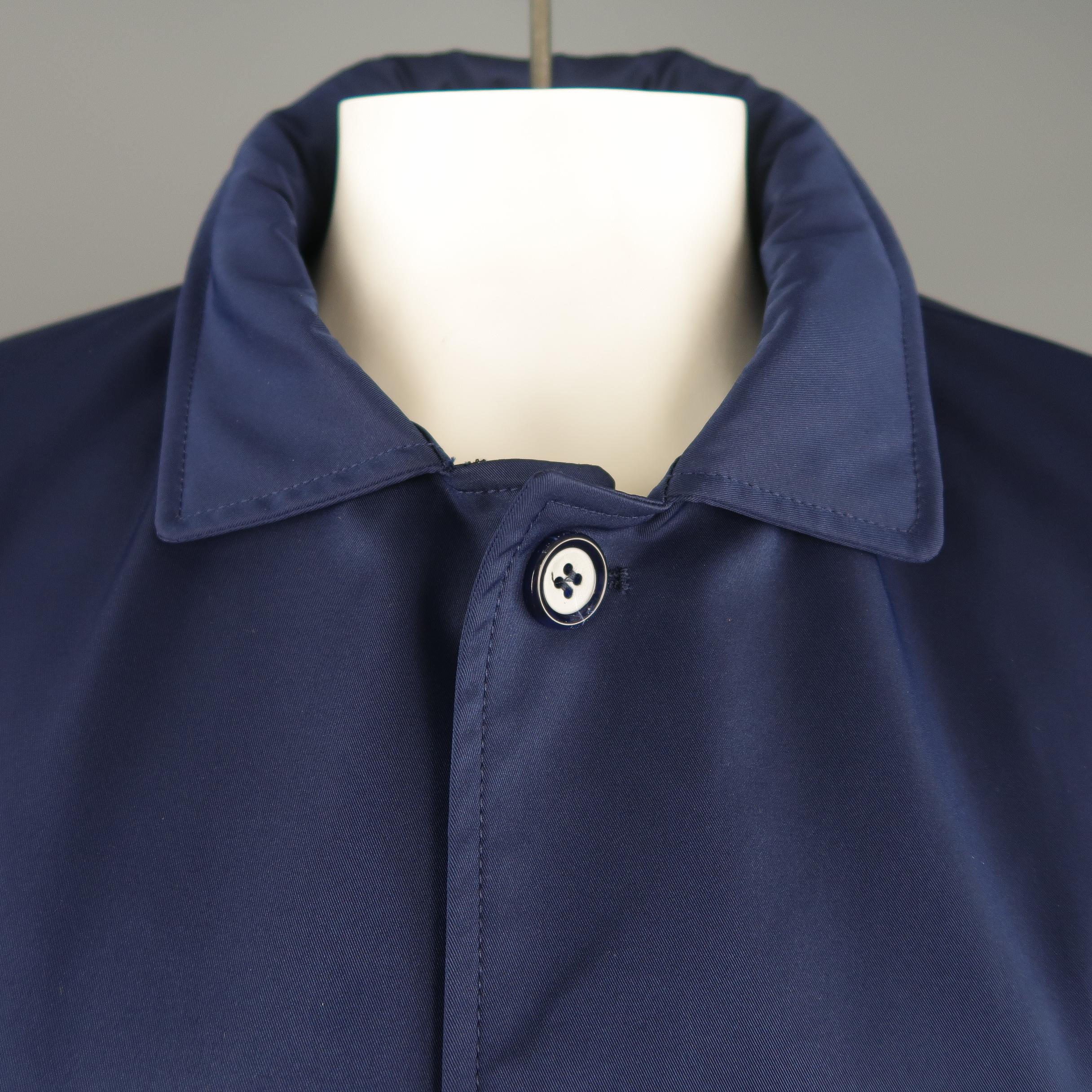 EREDI PISANO raincoat comes in navy twill with a optional zip hood collar, button up front, slanted pockets, button tab cuffs, and detachable zip pout vest liner. Made in Italy.
 
New with Tags. Retails: 1200.
Marked: (no size)
 
Measurements:
