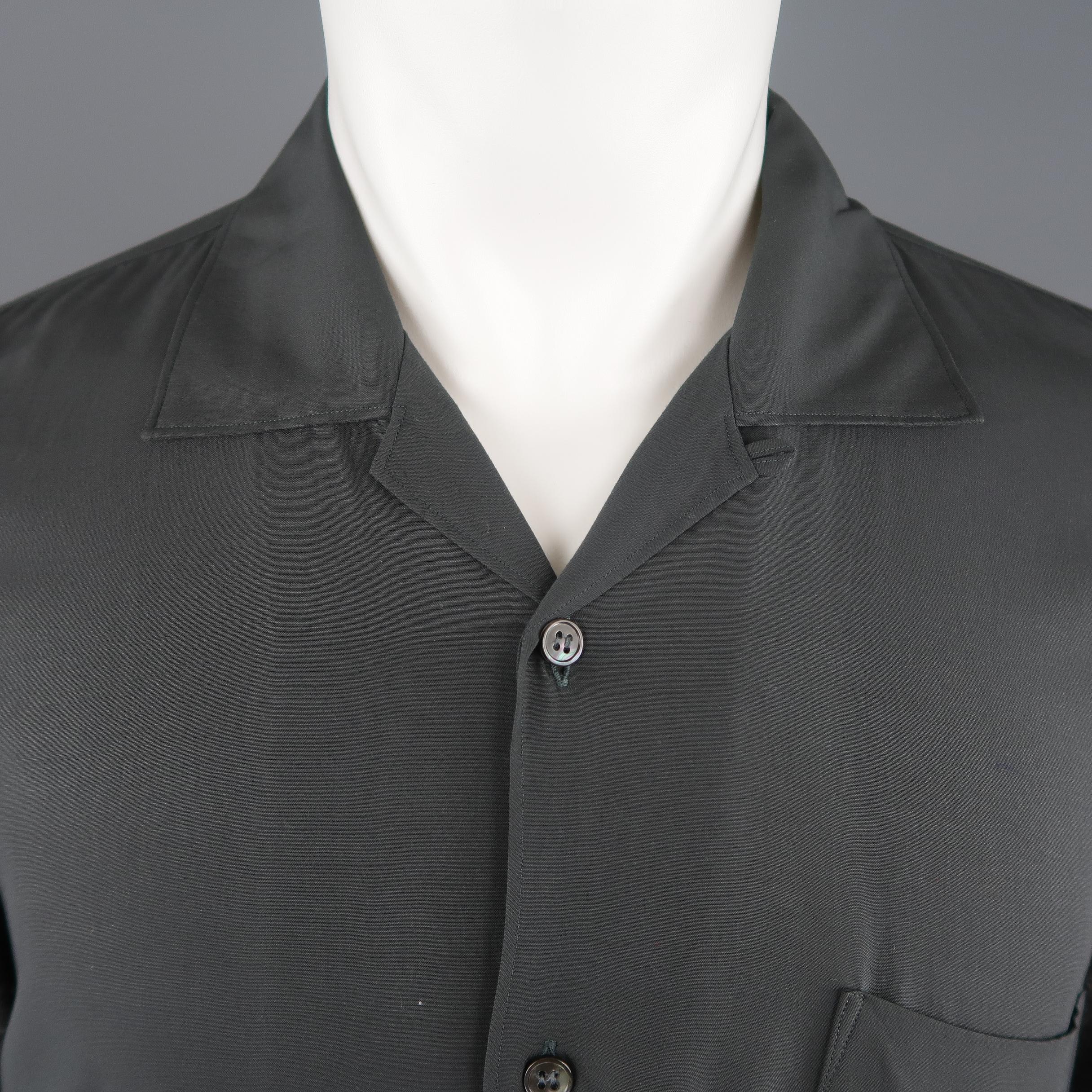 COMME des GARCONS shirt features a slate gray rayon body with a breast pocket and open collar with dark heather gray wool blend knit sleeves. Made in France.
 
Excellent Pre-Owned Condition.
Marked: M
 
Measurements:
 
Shoulder: 18 in.
Chest: 46