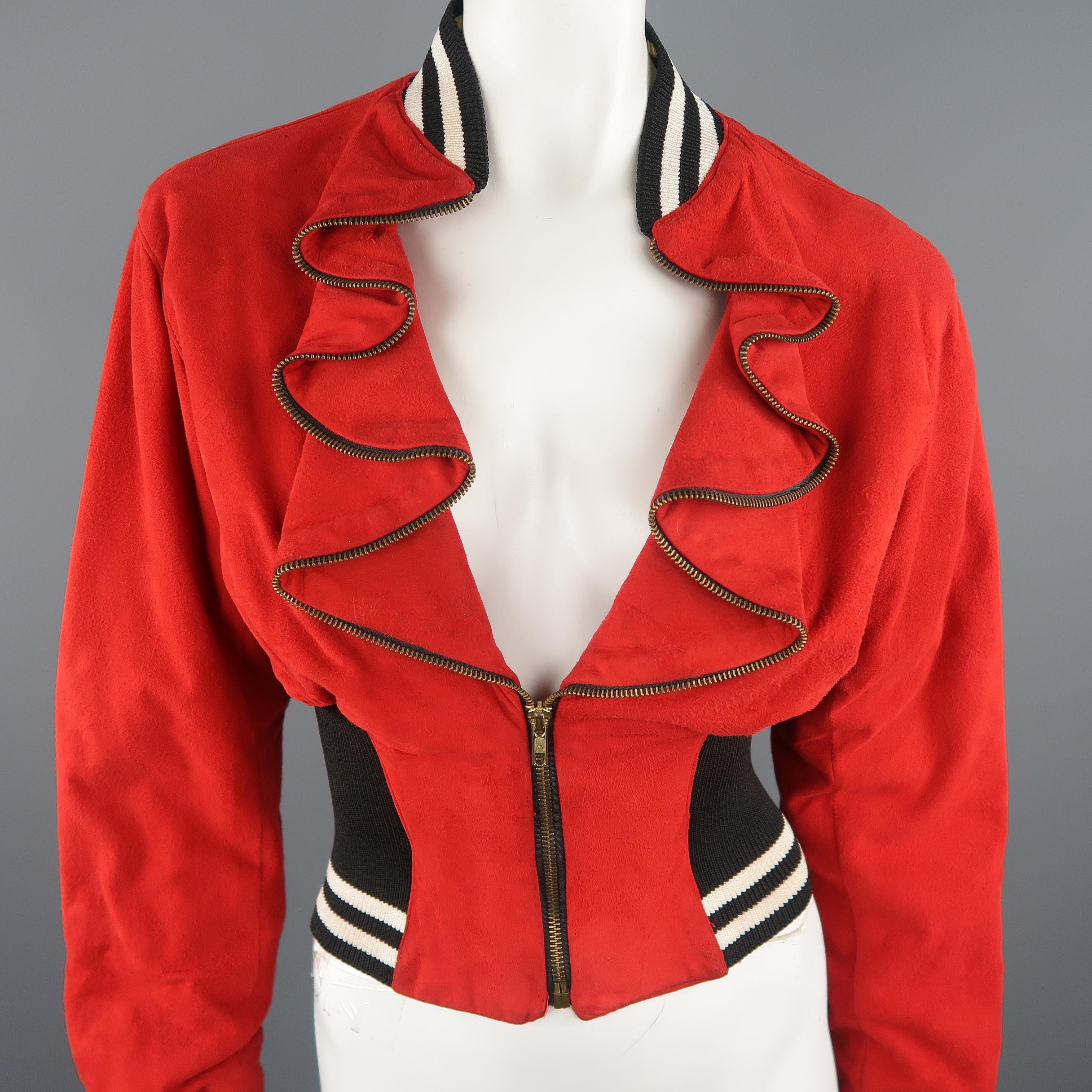 Vintage BYRON LARS circa 1990's baseball jacket comes in bold red suede with a black and white striped baseball collar, cuffs, and thick waistband, cropped hemline, and dark gold tone zip ruffled lapel and closure. Vintage / Minor wear. Made in