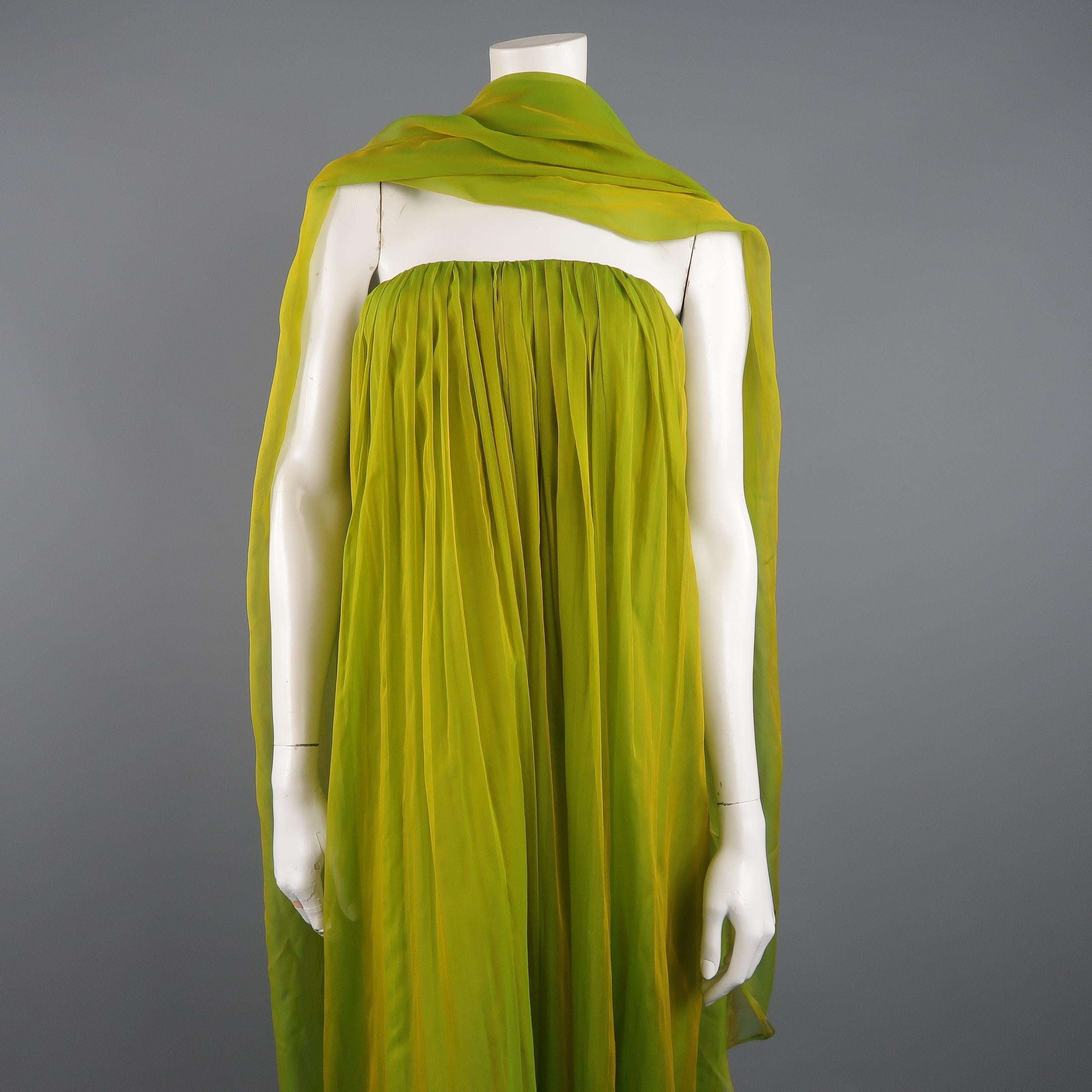 CAROLYNE ROEHM strapless gown comes in an iridescent green silk chiffon with a golden sheen and features a bustier top with pleated front and A line silhouette. Includes a matching chiffon shawl and extra panel of fabric. Wear on shawl. As-is. Made