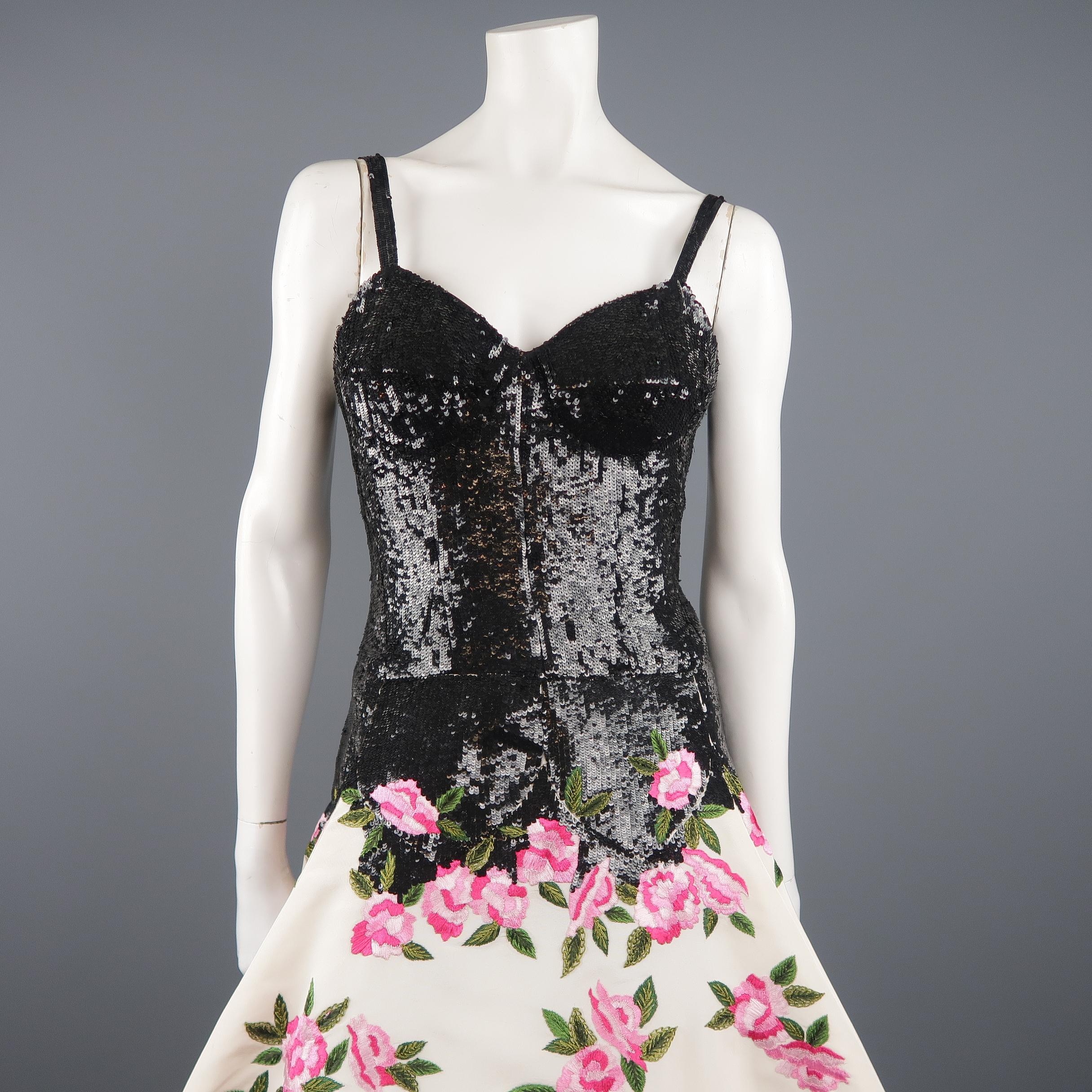 OSCAR DE LA RENTA evening gown features a black sequin sweetheart bustier bodice with a drop waist and straps, with a full tulle crinoline lined, cream silk taffeta skirt with pink floral embroidery throughout. Circa 2015. Made in USA.
 
New with