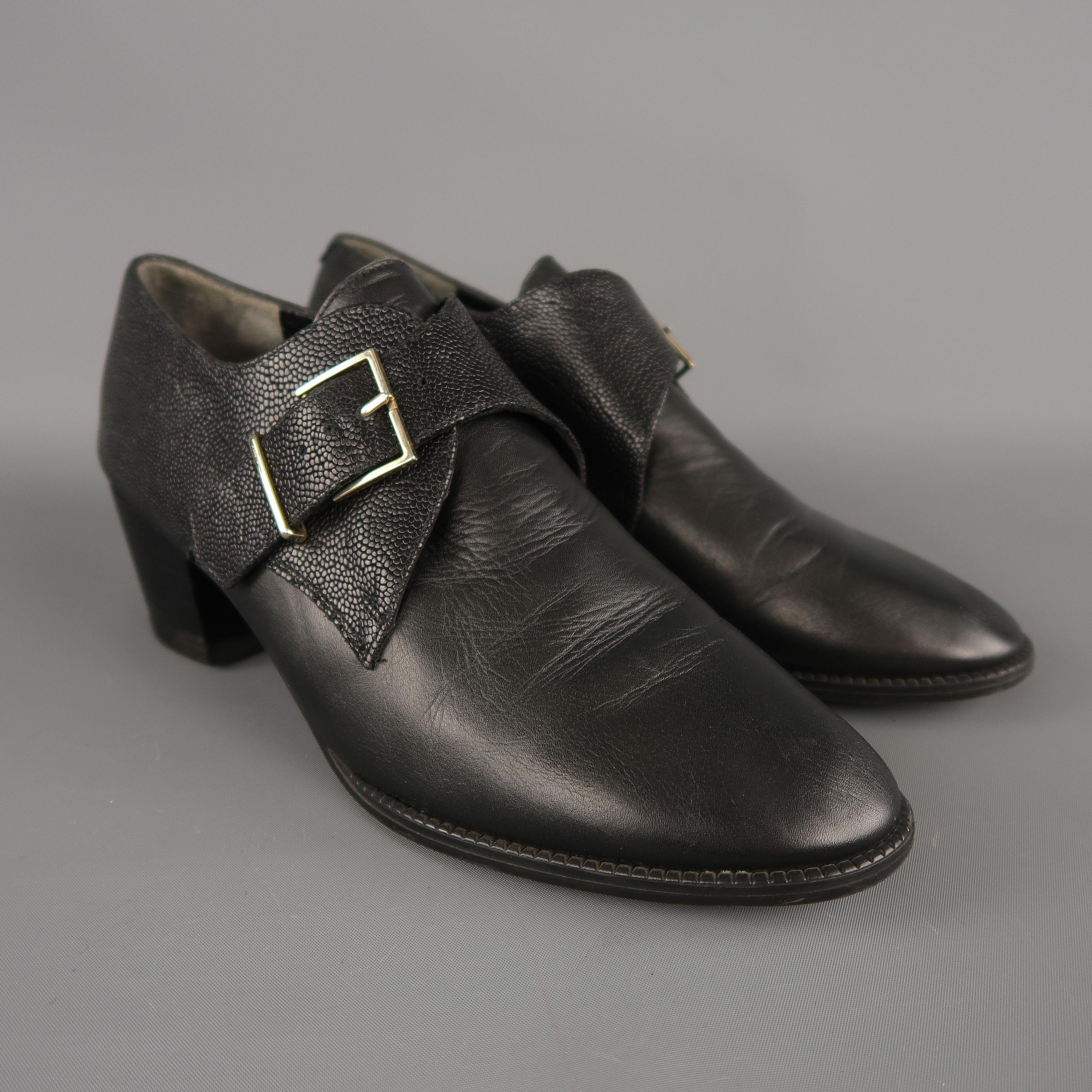 ROBERT CLERGERIE shoes come in smooth black leather with a chunky heel, and lizard textured leather monk strap panel. Made in France. retail price $542.00
 
 
Excellent Pre-Owned Condition.
Marked: IT 38.5
 
Measurements:
 
Heel: 1.75 in.