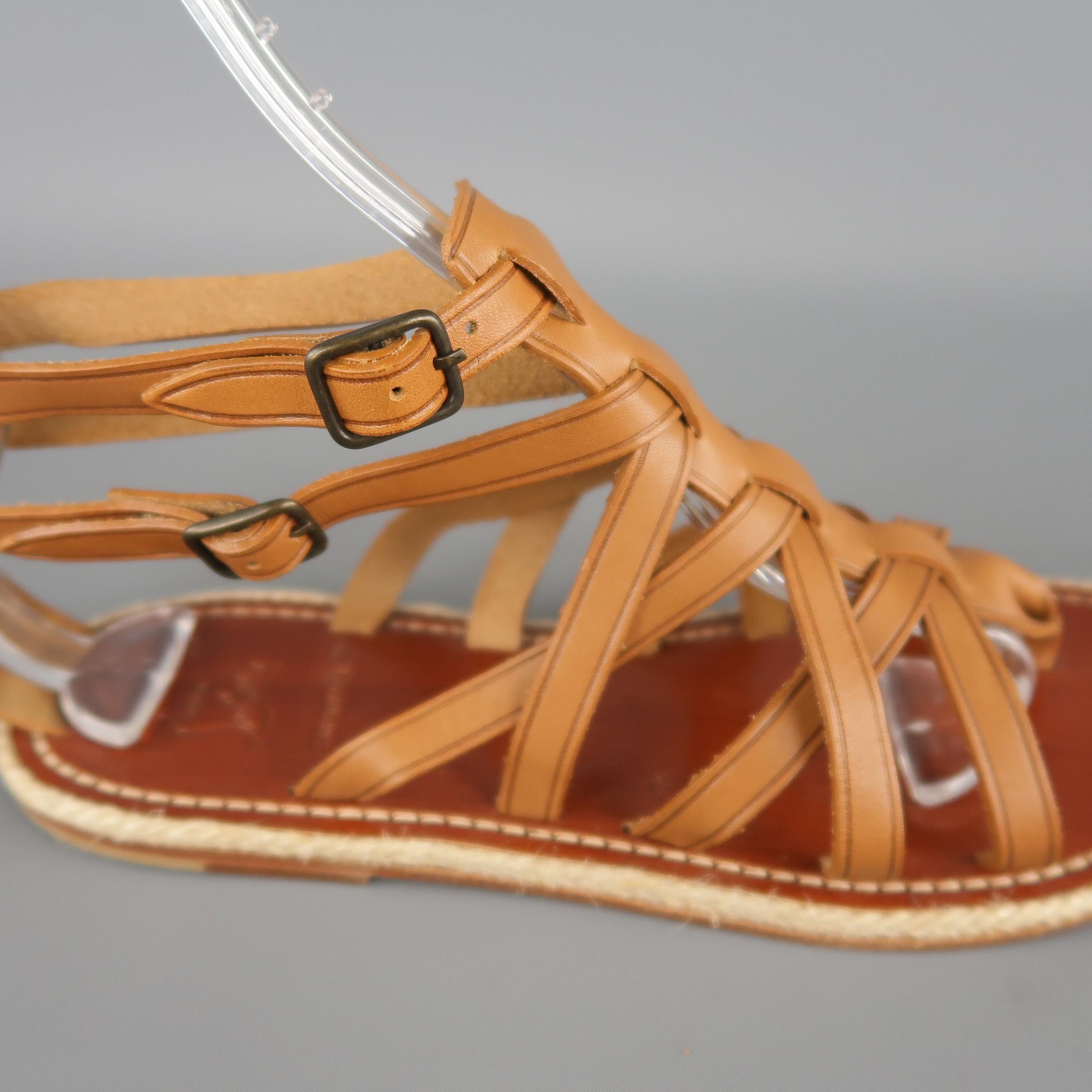 CHRISTIAN LOUBOUTIN gladiator style sandals features tan crossed straps and a braided mid sole. Made in Spain.
 
Excellent Pre-Owned Condition.
Marked: IT 40
 
10.25 x 3.75 in.
