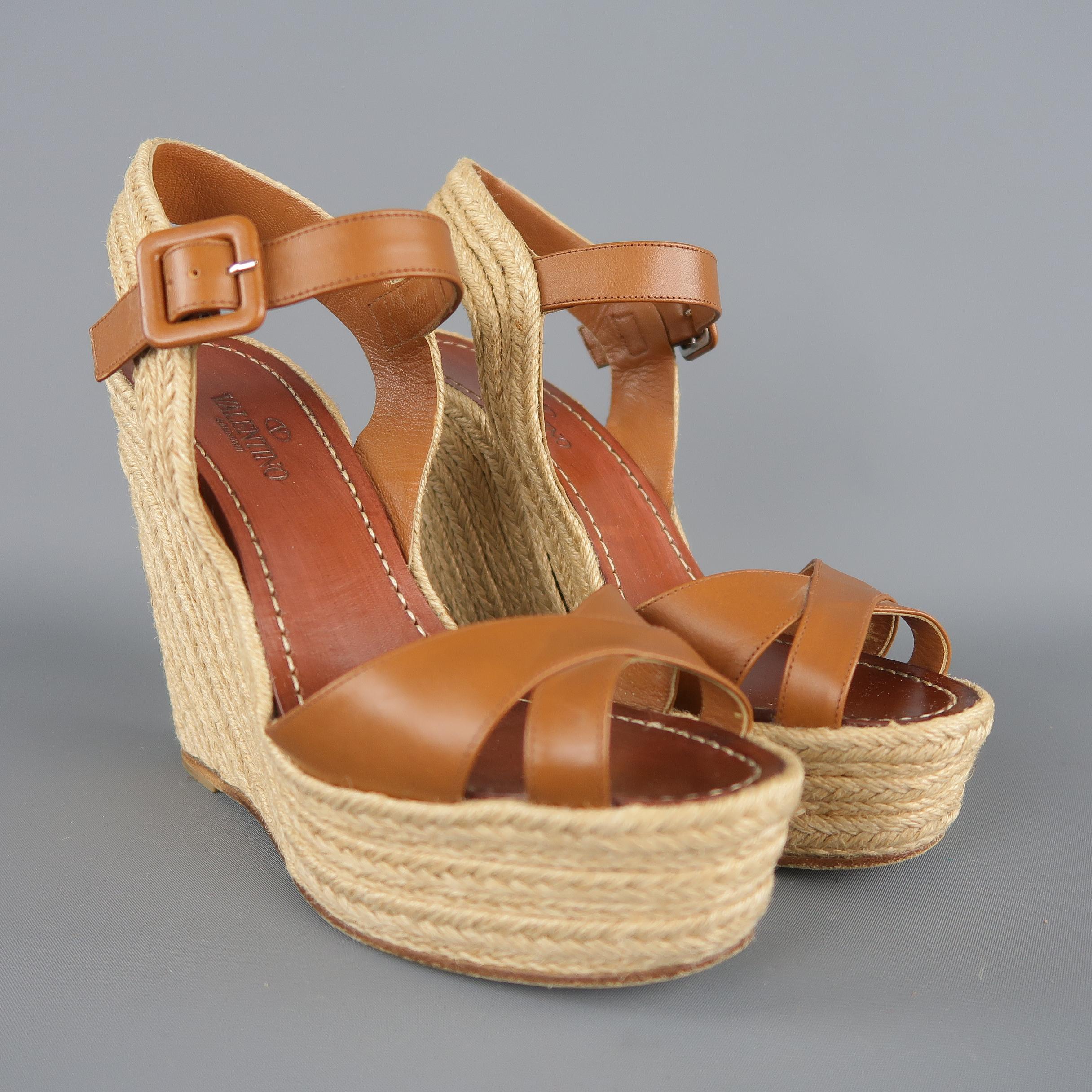 VALENTINO sandals feature tan leather cross straps, ankle harness, and natural braided rope covered espadrille platform wedge.  Made in Spain. retail price $690,00.
 
Excellent Pre-Owned Condition.
Marked: IT 38.5
 
Measurements:
 
Heel: 5