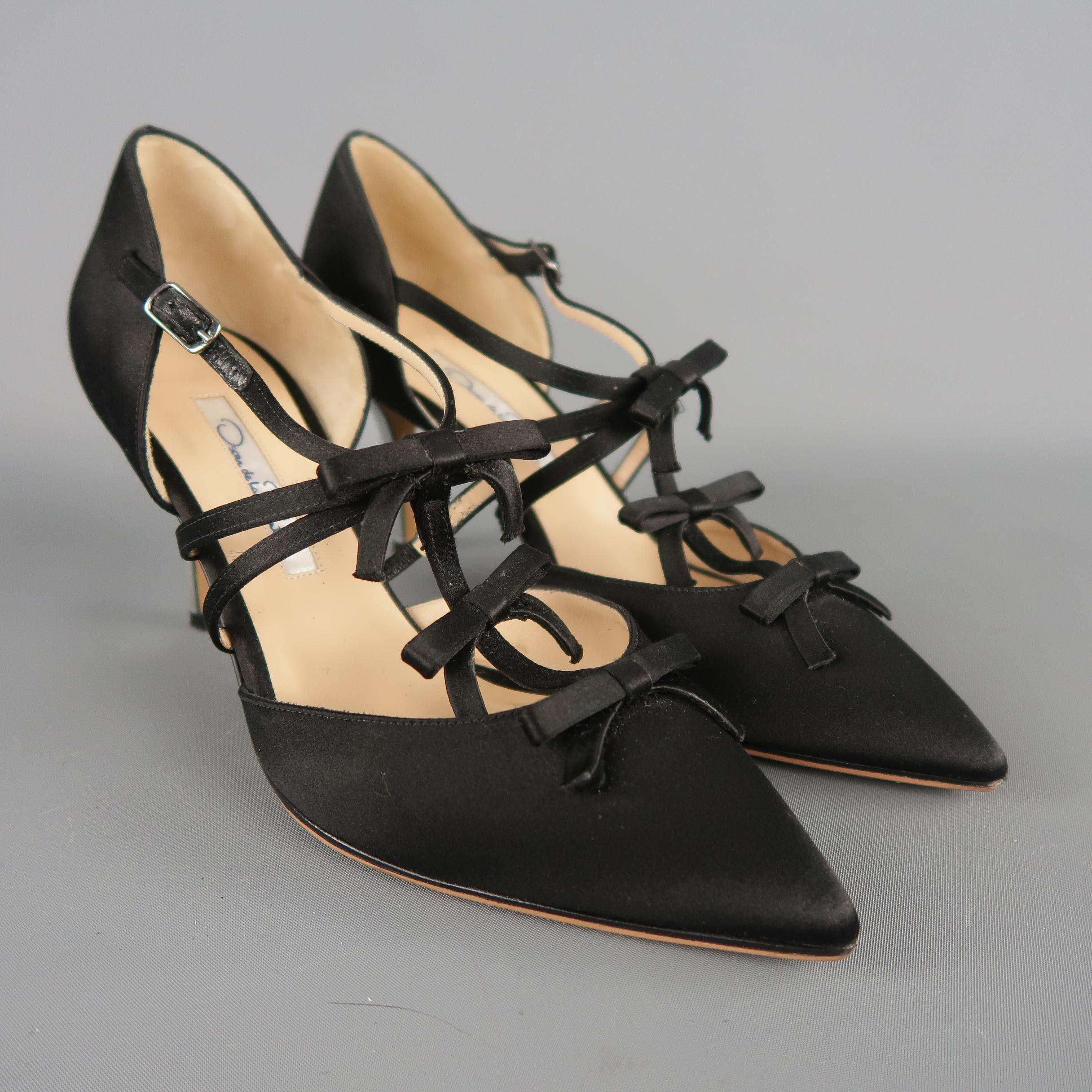 OSCAR DE LA RENTA pumps come in black silk satin with a pointed toe, silver metallic leather covered stiletto heel, and T strap with bows. Made in Italy.
 
Excellent Pre-Owned Condition.
Marked: IT 36.5
 
Measurements:
 
Heel: 3 in.