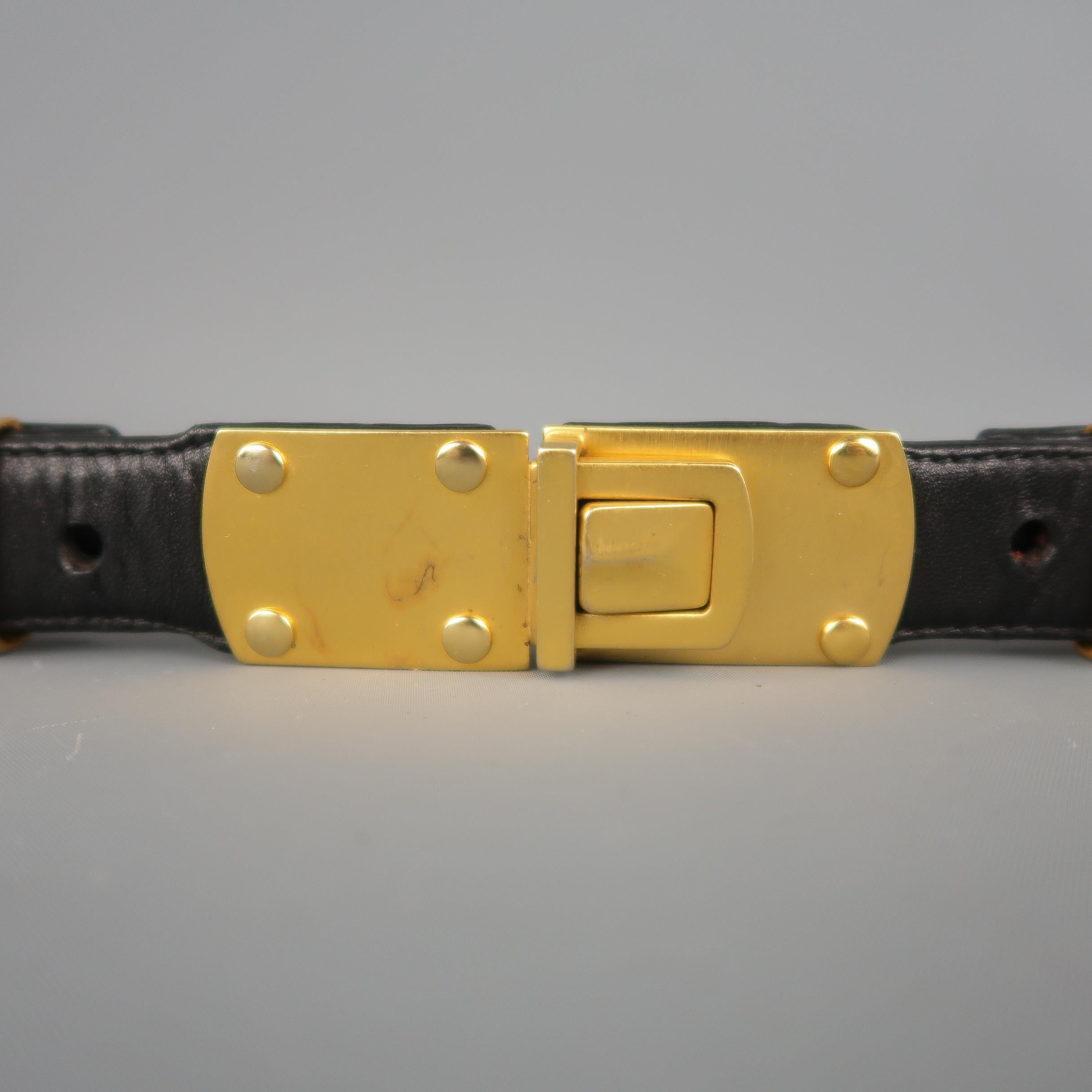 Vintage DONNA KARAN waist belt features a three strand yellow gold tone chain strap with leather detailed clasp closure.
 
Good Pre-Owned Condition.
Marked: M
 
Measurements:
 
Width: 1.5 in.
Fits: 28 in.