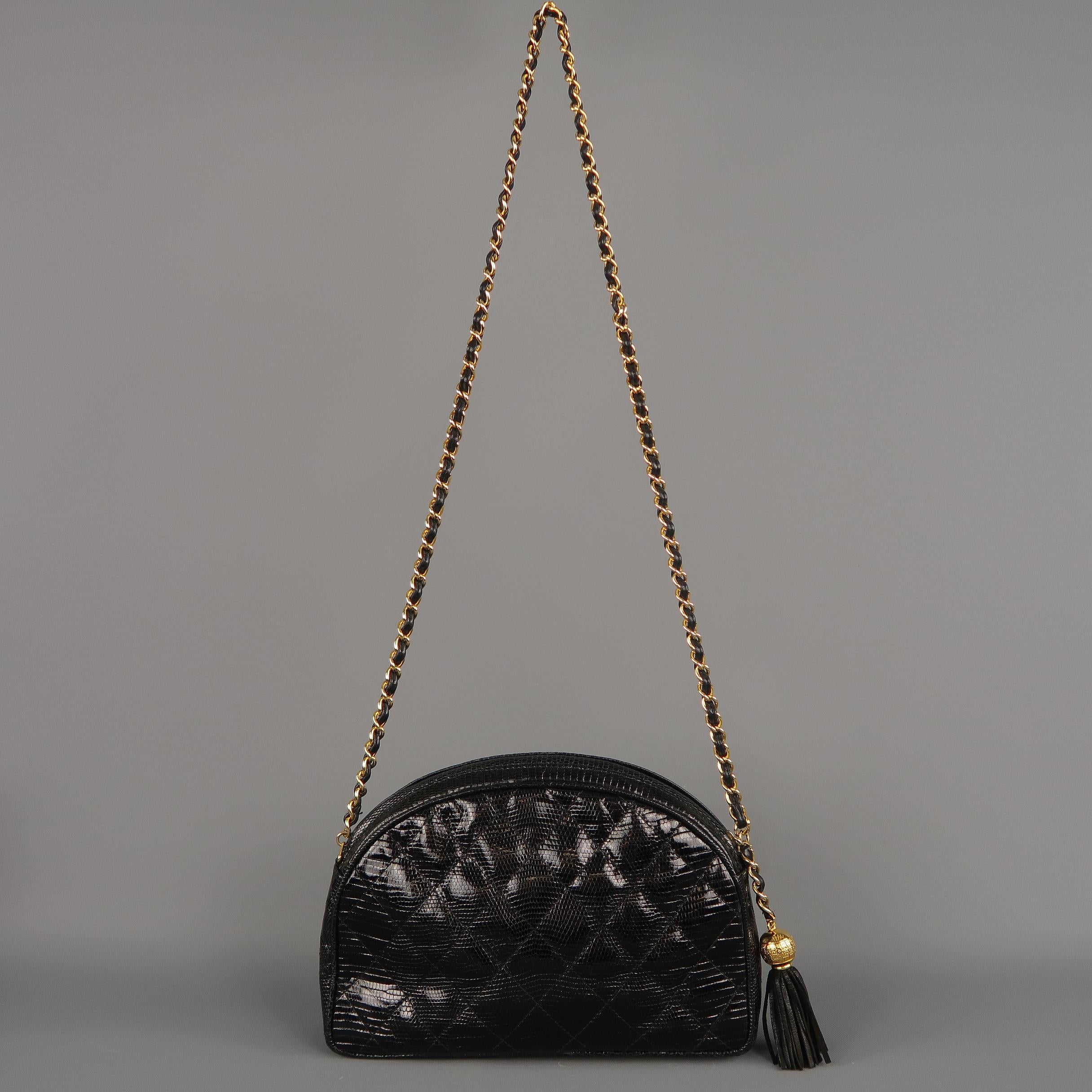 Vintage early 1990's CHANEL bag comes in quilted lizard skin with a half moon pouch shape, yellow gold tone metal, leather woven chain strap, top zip with gold tone CC emblem tassel pull, and leather interior.  Made in Italy.

Excellent Pre-Owned