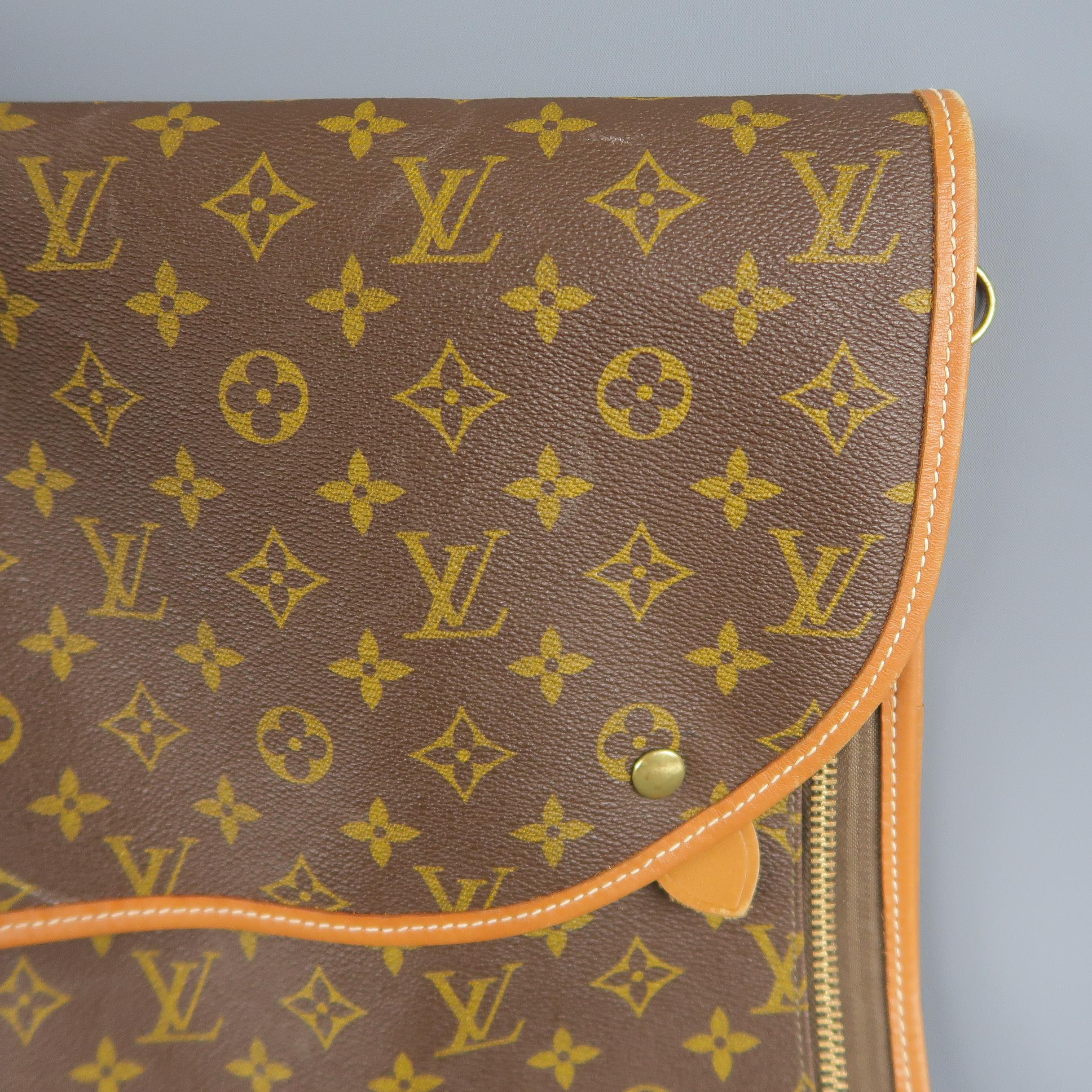 Vintage LOUIS VUITTON luggage interior pouch bag comes in classic brown and tan monogram coated canvas in a large rectangular shape with a flap double snap closure, vachetta leather piping, side hoops, and double zip interior closure. Minor wear