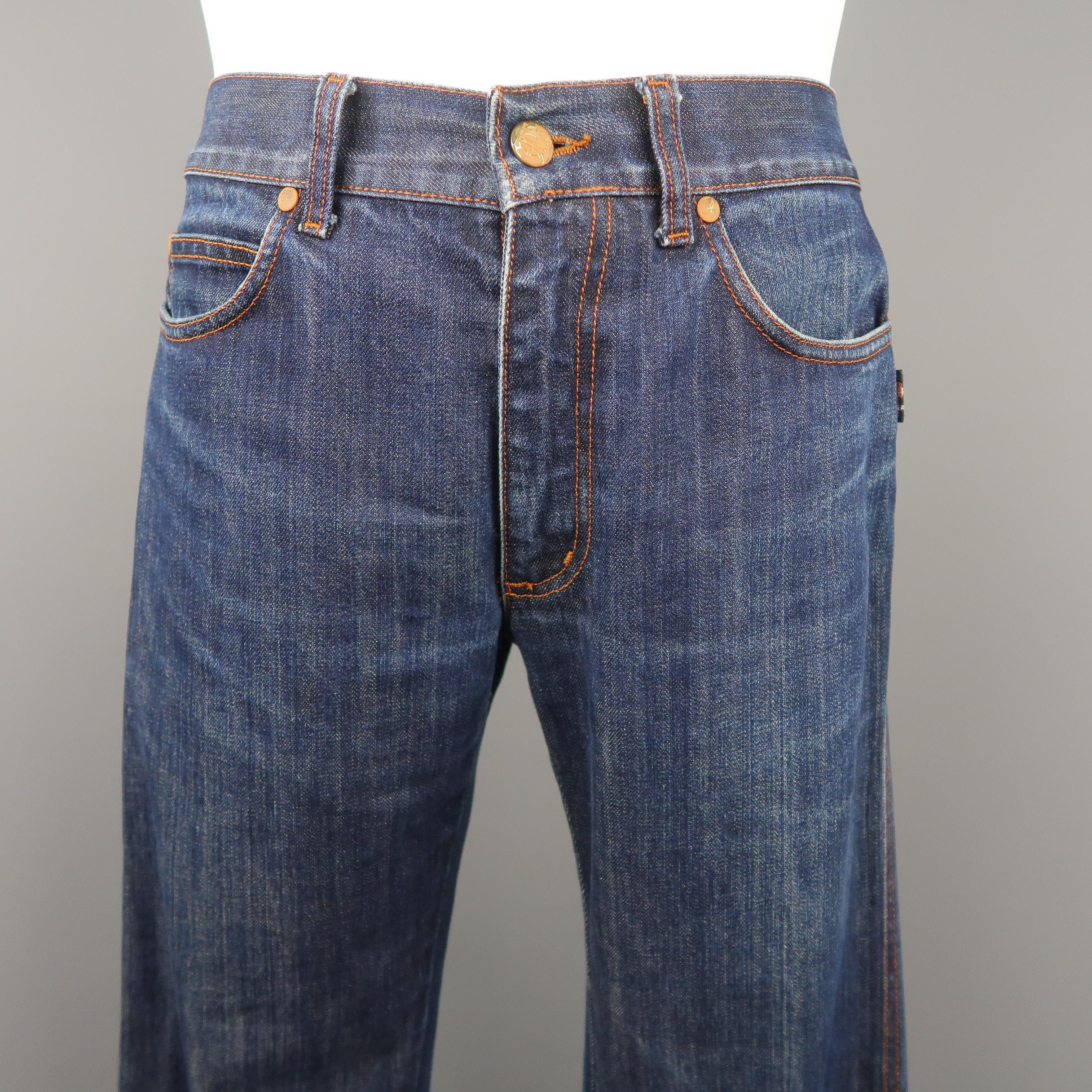Vintage JPG JEANS by JEAN PAUL GAULTIER jeans come in dark washed denim with rust contrast stitching and hardware and extended cuffed hem with print on left leg. Made in Italy.
 
Excellent Pre-Owned Condition.
Marked: 31
 
Measurements:
 
Waist: 31