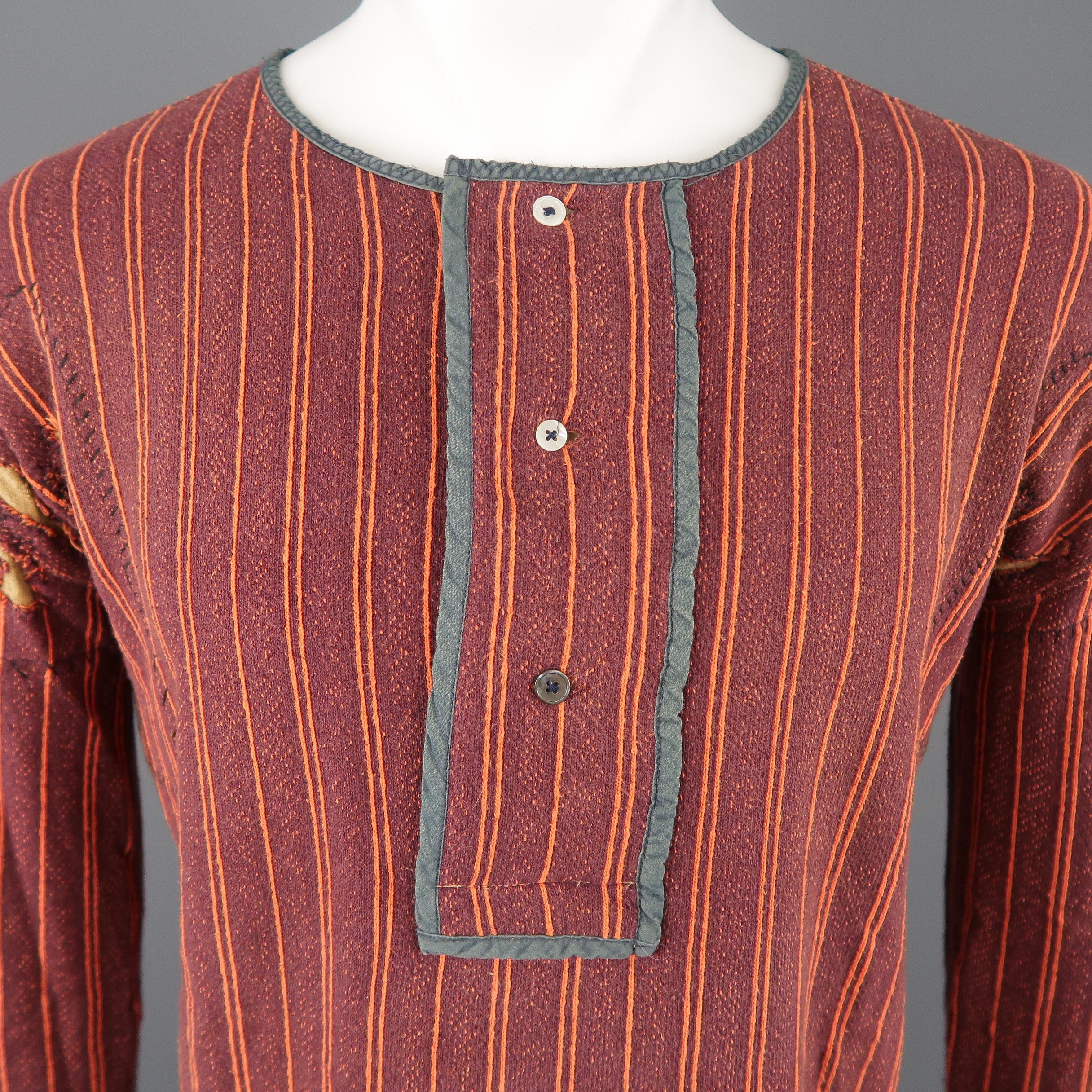 SUNSET pullover comes in burgundy and orange striped jersey knit with a round collar, teal trimmed Henley half button closure, and distressed details with gold inner patch hand stitch embellishments. Made in Portugal.
 
Excellent Pre-Owned