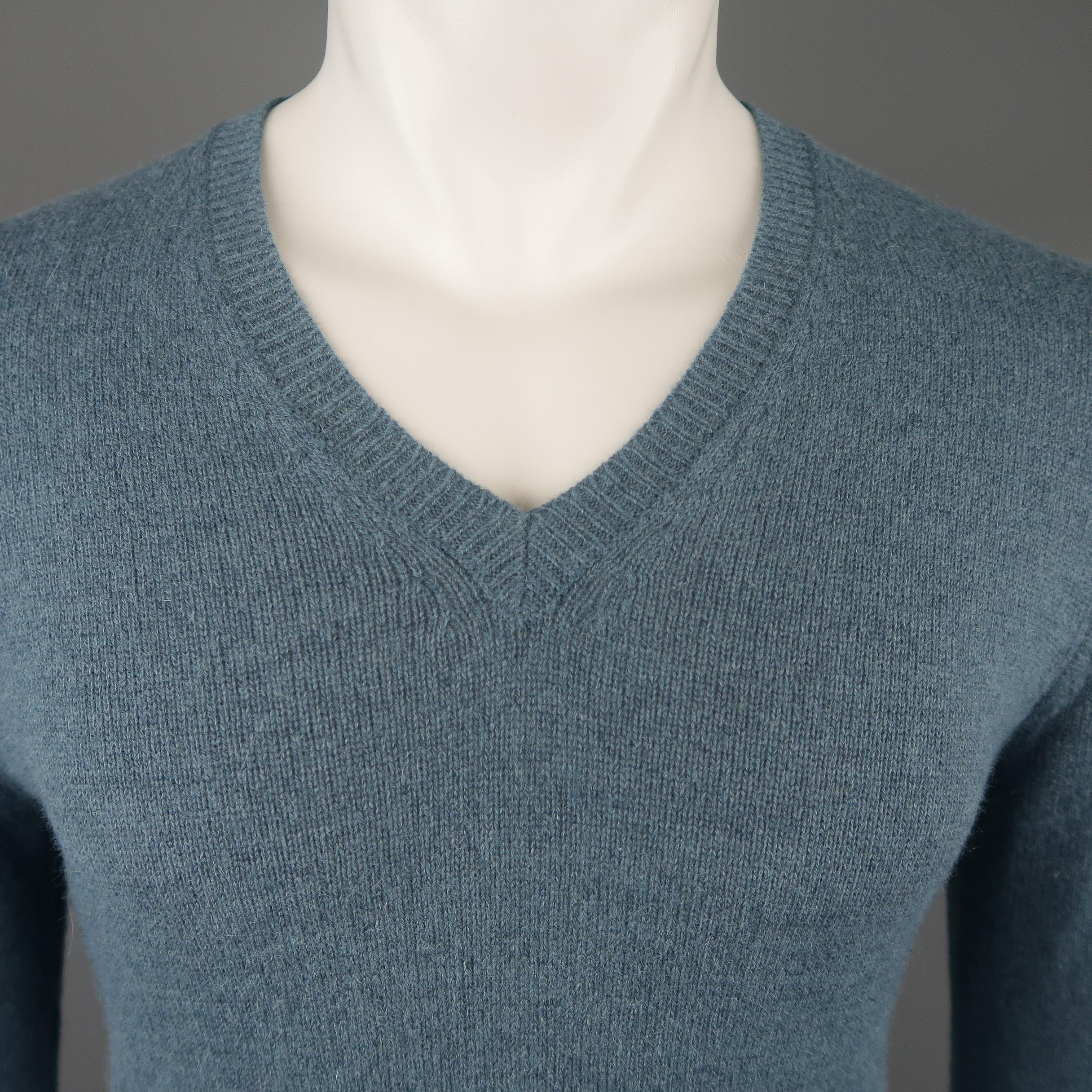 DRIES VAN NOTEN pullover sweater comes in a muted teal heathered alpaca blend knit with a v neck and ribbed waistband. Made in Belgium.
 
Excellent Pre-Owned Condition.
Marked: Small
 
Measurements:
 
Shoulder: 17 in.
Chest: 40 in.
Sleeve: 28