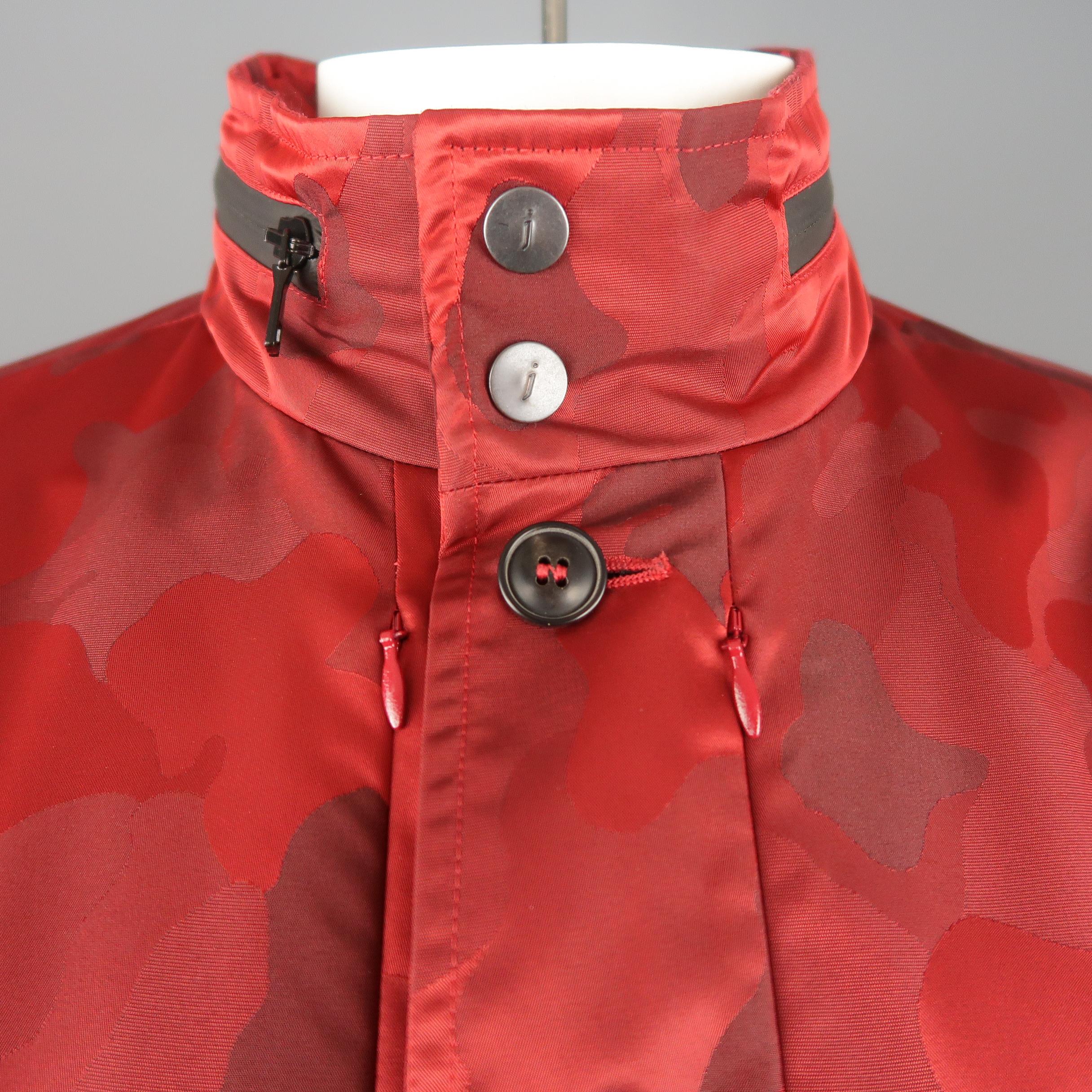 JOHN VARVATOS jacket comes in red camouflage jacquard fabric with a button up front, high collar with double snap and optional zip out hood, hidden zip chest pockets, and patch flap military style pockets. Made in Italy.
 
Excellent Pre-Owned