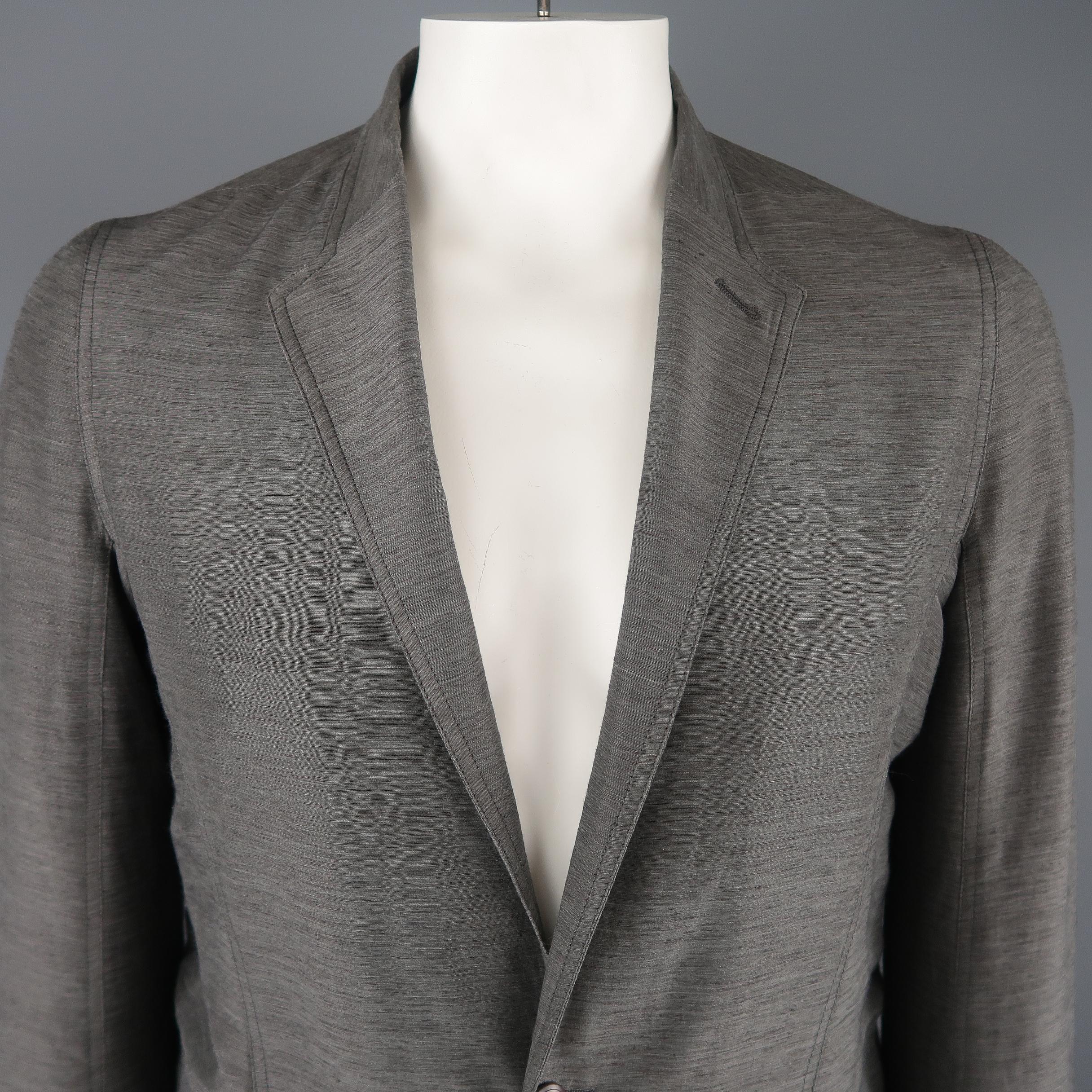 RICK OWENS Spring 2014 Collection sport coat comes in a light weight linen, silk, poly blend heathered material with a band collar notch lapel, single button closure, flap pockets, button cuffs, and half liner. small tear on back seam. As-is.  Made