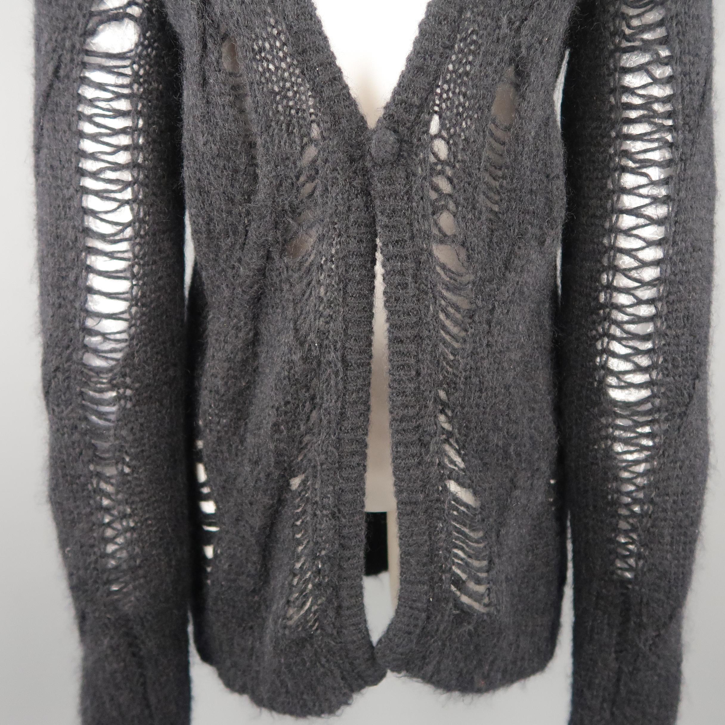 GIVENCHY by RICCARDO TISCI cardigan comes in a fuzzy wool mohair blend cable knit with all over distressing details, deep V neck, oversized silhouette, and single button closure. Care tag removed.
 
Excellent Pre-Owned Condition.
Marked: (no size)
