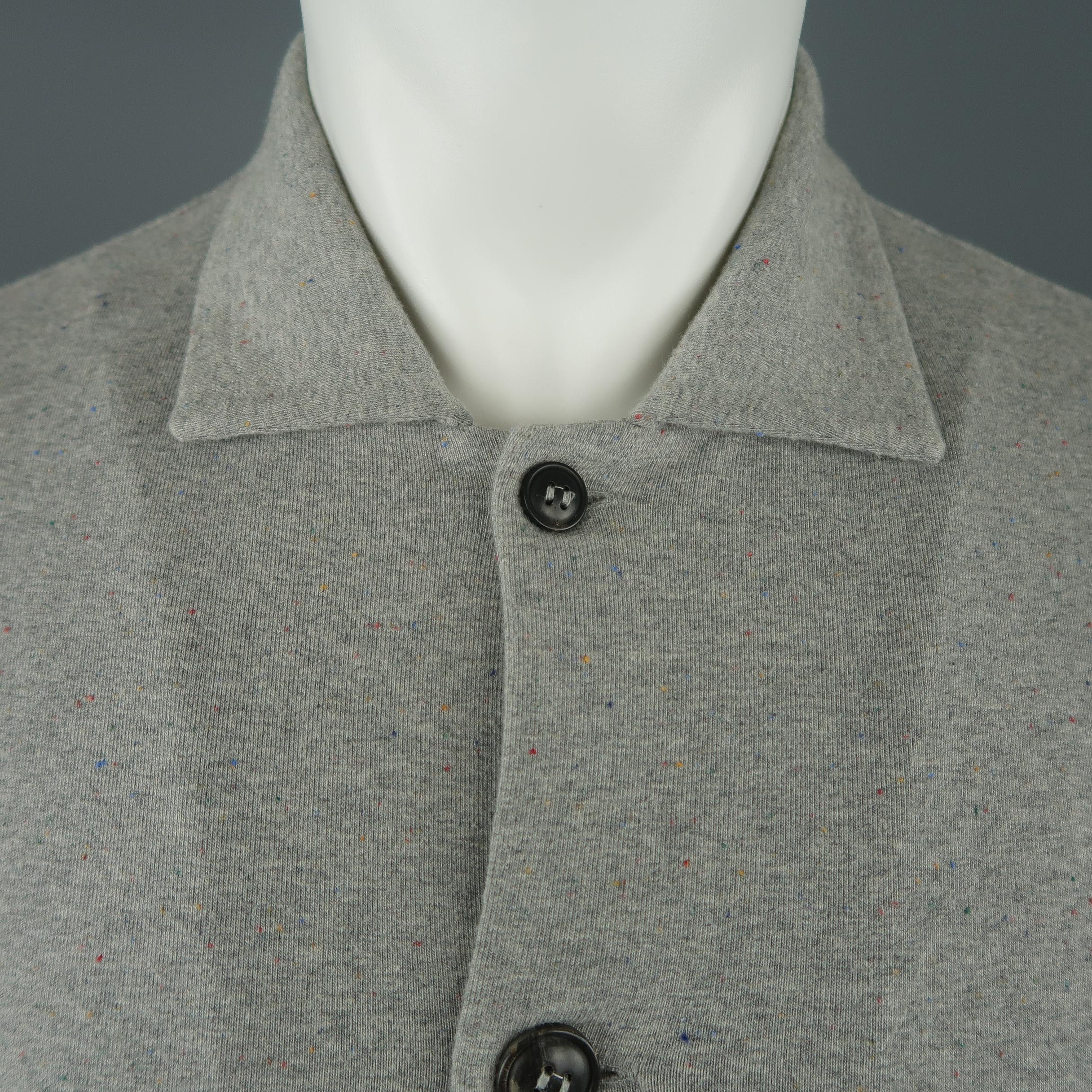 HOMECORE jacket comes in a light weight heather gray jersey knit with multi-color speckled pattern throughout featuring a pointed collar, slanted slit pockets, and button up front. Made in Portugal.
 
Excellent Pre-Owned Condition.
Marked: S
