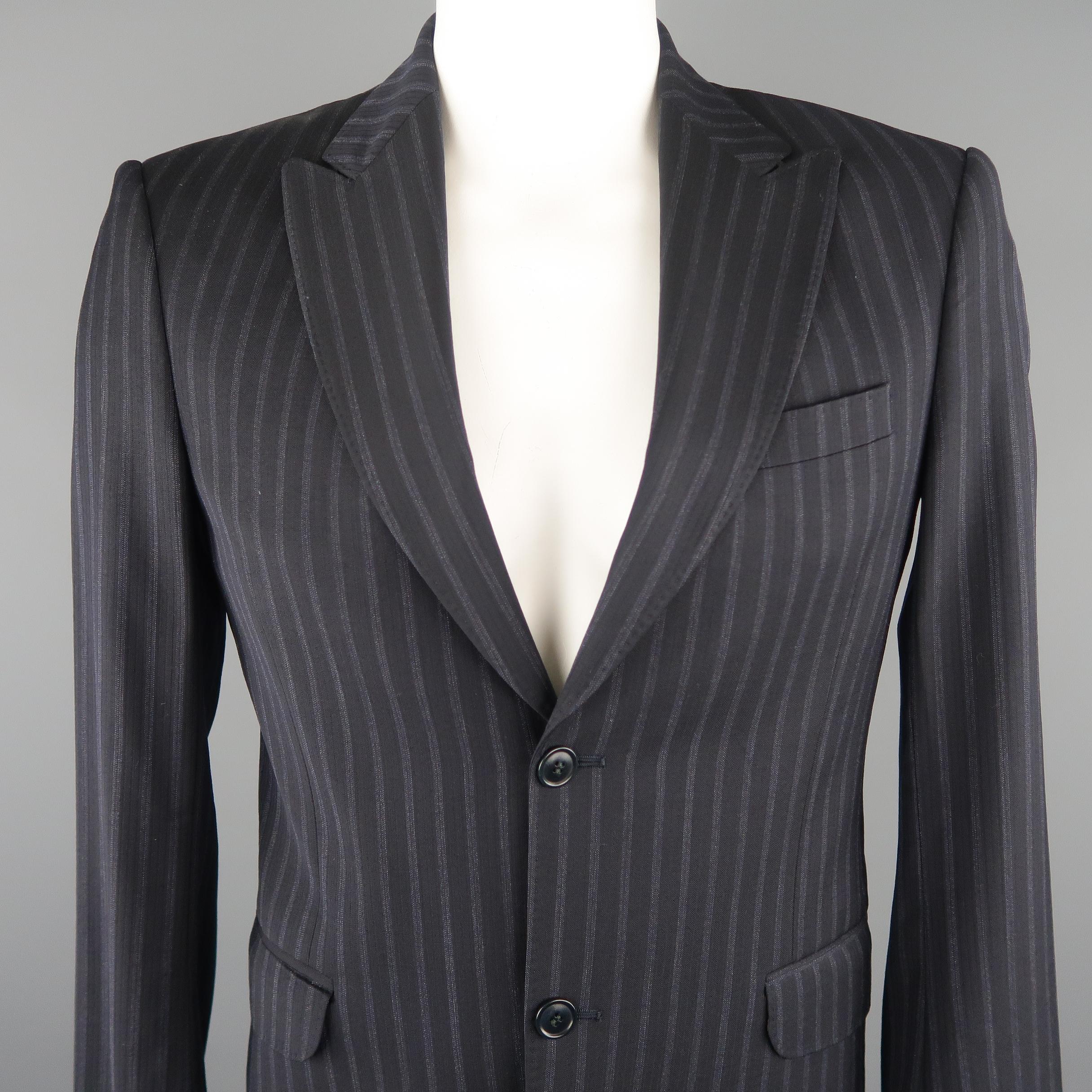 KENZO blazer comes in a black tone in a striped wool material, featuring a peak  lapel, slit and flap pockets, 2 buttons closure, single breasted and a slim fit. Made in France.
 
Excellent Pre-Owned Condition.
Marked: 48
 
Measurements:
 
Shoulder: