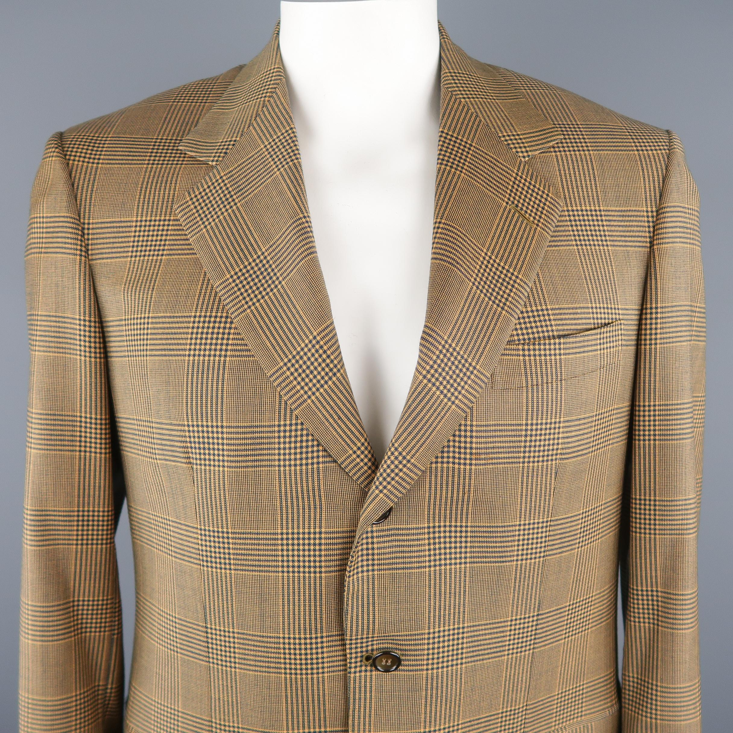 BRIONI blazer comes in gold and navy tones in a plaid wool material, featuring a notch lapel, slit and flap pockets, 3 buttons closure, single breasted. Presenting a light spot at front.  Made in Italy.
 
Excellent Pre-Owned Condition.
Marked: 50