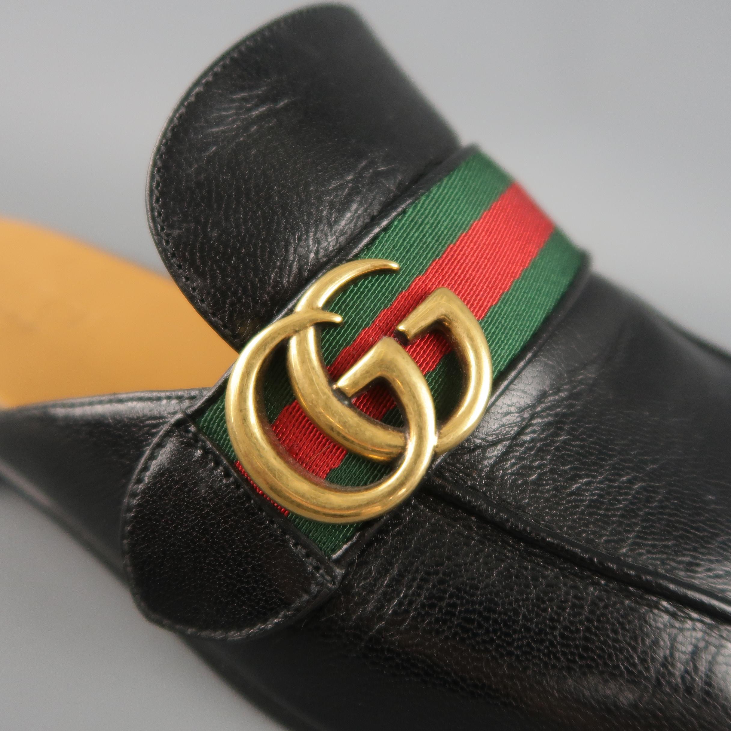 GUCCI Princetown Slipper mule loafers come in smooth black leather with an apron toe and a red and green stripe webbing strap adorned with a retro antique gold tone metal GG. Includes box, dust bags, and authenticity card. Made in Italy. Retail