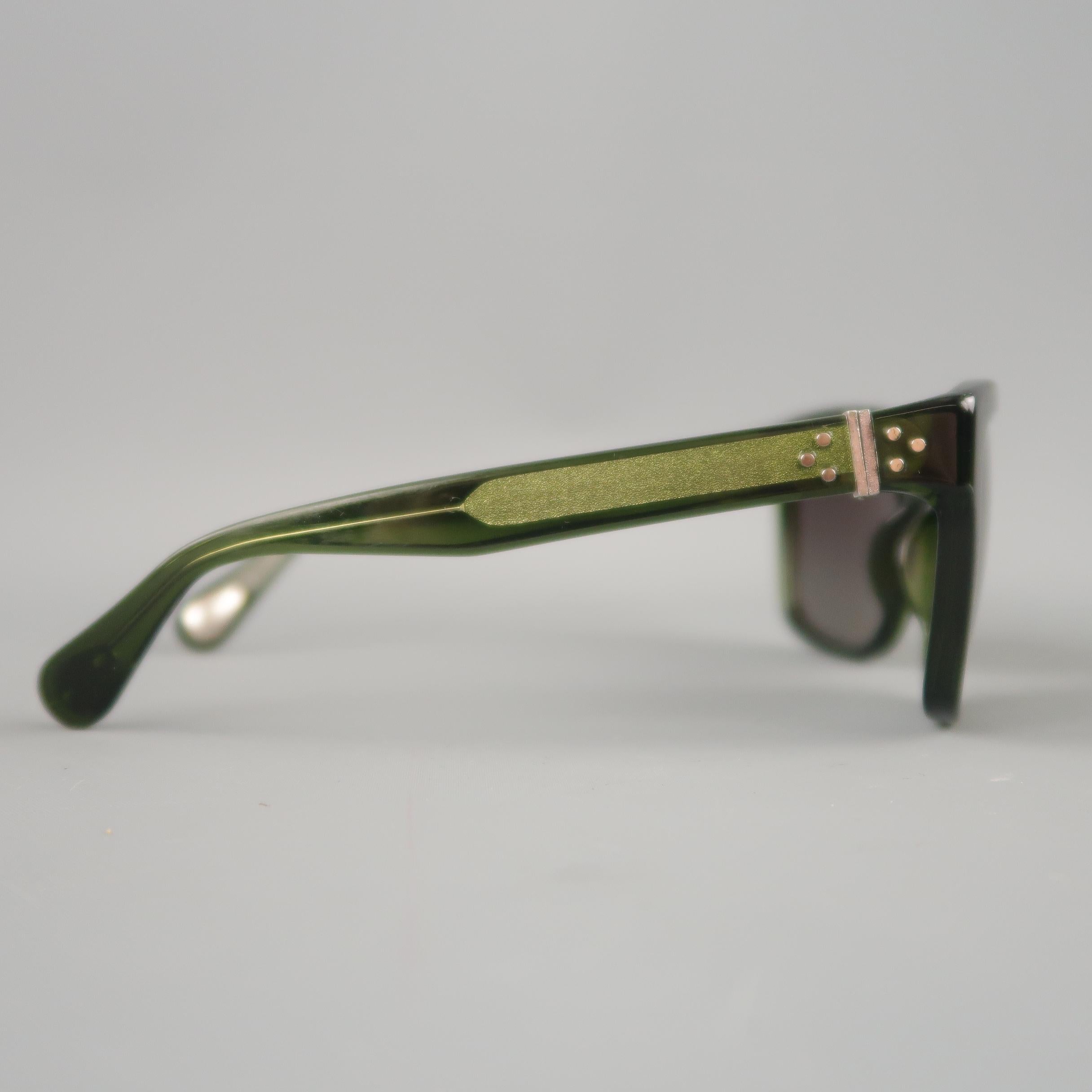 ANN DEMEULEMEESTER D Frame sunglasses come in clear green acetate with Sterling Silver accents and square black lenses. With Case & Box. Made in Italy.
 
Excellent Pre-Owned Condition. Retails: $700.00.
Marked:
 
Measurements:
 
Length: 14 