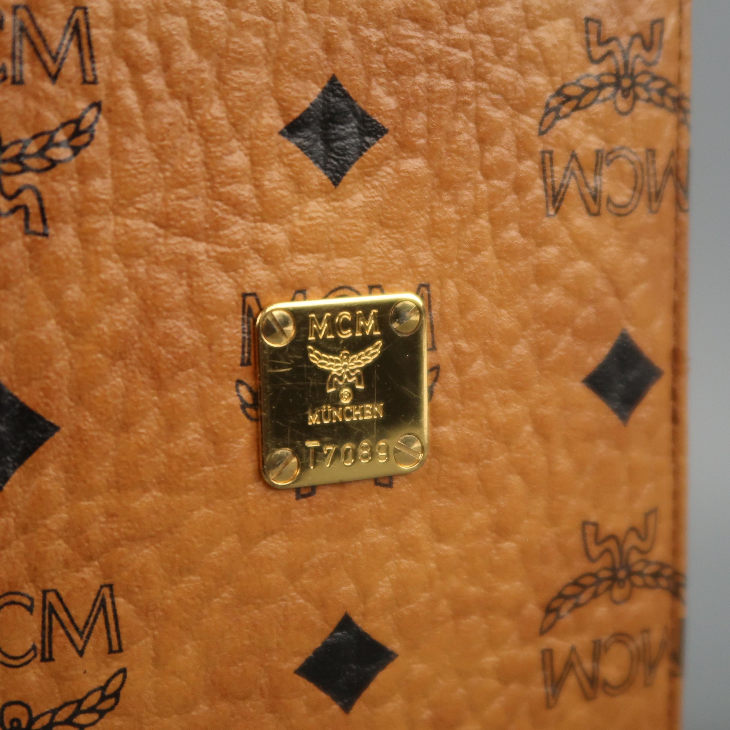 MCM passport holder comes in tan textured leather with black monogram print throughout, gold tone metal plate, and inner card storage. With box, dust bag, and card. Minor wear on interior.
 
Excellent Pre-Owned Condition.
 
5.5 x 3.75 in.