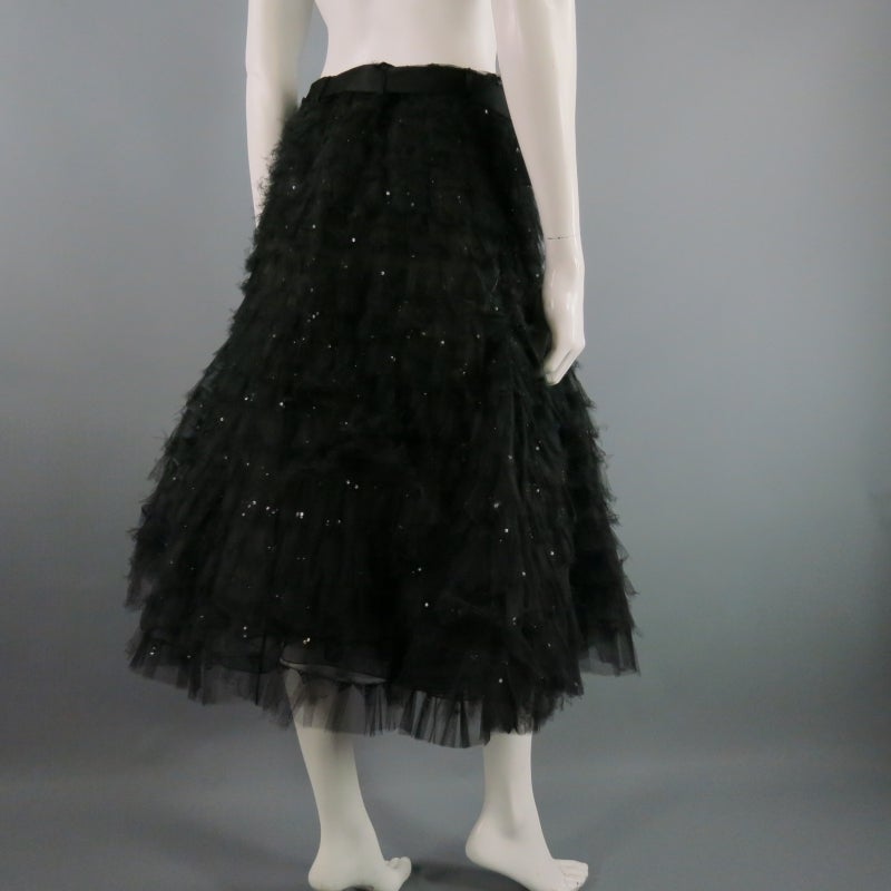 OSCAR DE LA RENTA does romance well.  This skirt is triple layered.  2 inside layers of voluminous pleats add body.  Top layer has a dramatic flare a-line shape in tiered layers of black tulle with scattered black sequins.  Black silk belt.  Made in