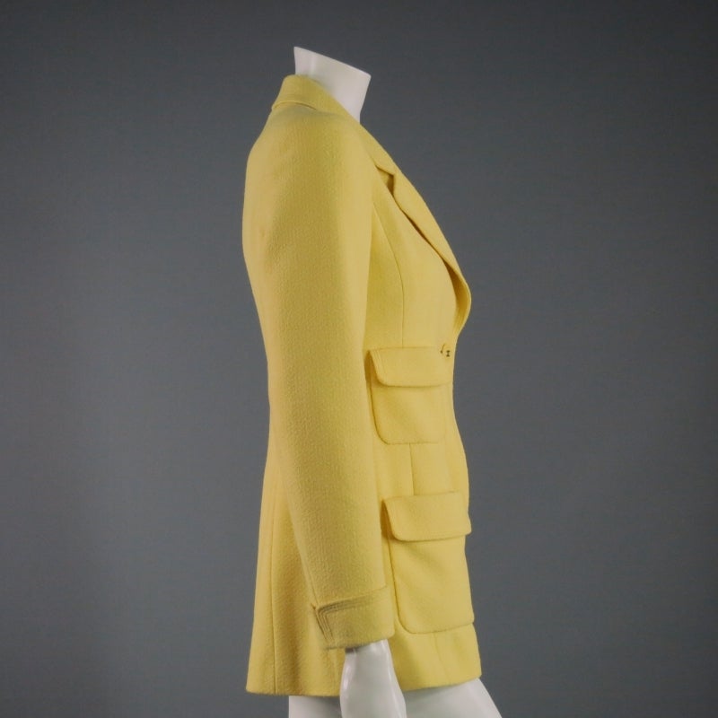Beautiful yellow wool/nylon blend coat by Chanel. This textured tweed design is single breasted and made in France.
 
Excellent Pre-Owned Condition Marked: Size 36FR
 
Measurements:
 
Shoulder: 18 inches
Sleeve: 24 inches
Bust: 34