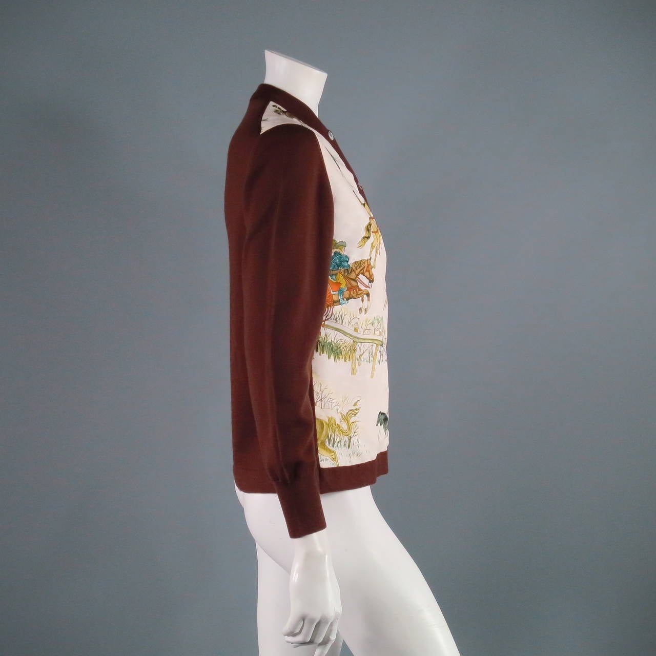 Beautiful Hermes silk winter illustration graphic with wool sleeves. A fabulous holiday addition. Made in France.
  
Measurements:
Shoulder to Shoulder- 17 inches
Bust- 19 inches
Length of Cardigan- 23 inches
Length of Sleeve- 23 inches