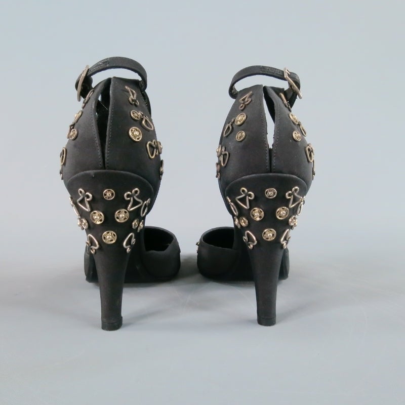 Fabulous vintage CHANEL pumps. An amazing archive find, these ankle strap D'Orsay's come in a black fabric embellished with silver snaps and hooks for a chic pop art effect. A true collector's item for an fan of the fashion house. Made in Italy.
 