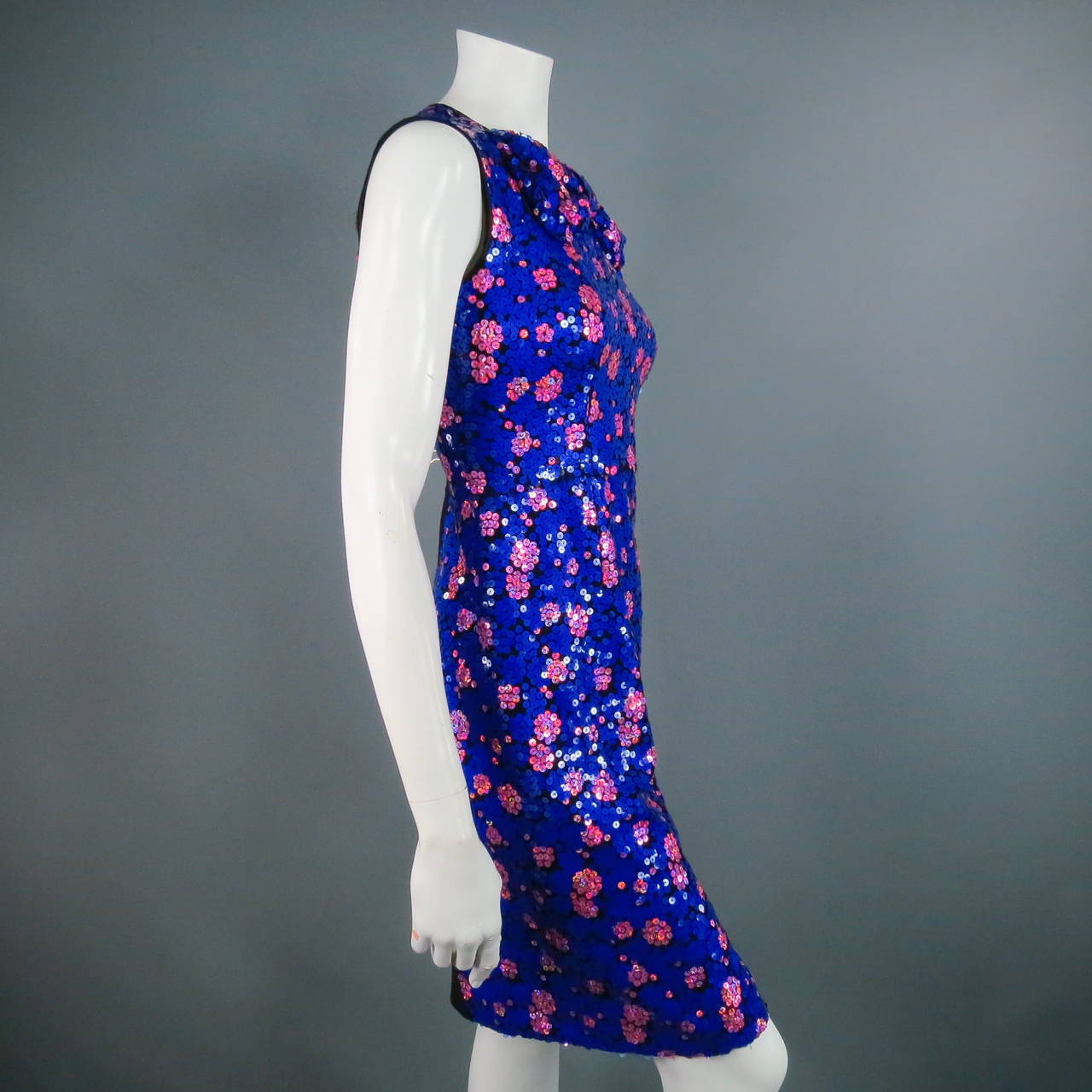 Flirty sequined silk cocktail dress by MARC JACOBS. A fun 1960's mod inspired sleeveless style in royal blue and pink print featuring a large bow detail along the neckline.  Retail at $2700
 
Excellent Pre-Owned Condition.
 
Measurements:
Shoulder: