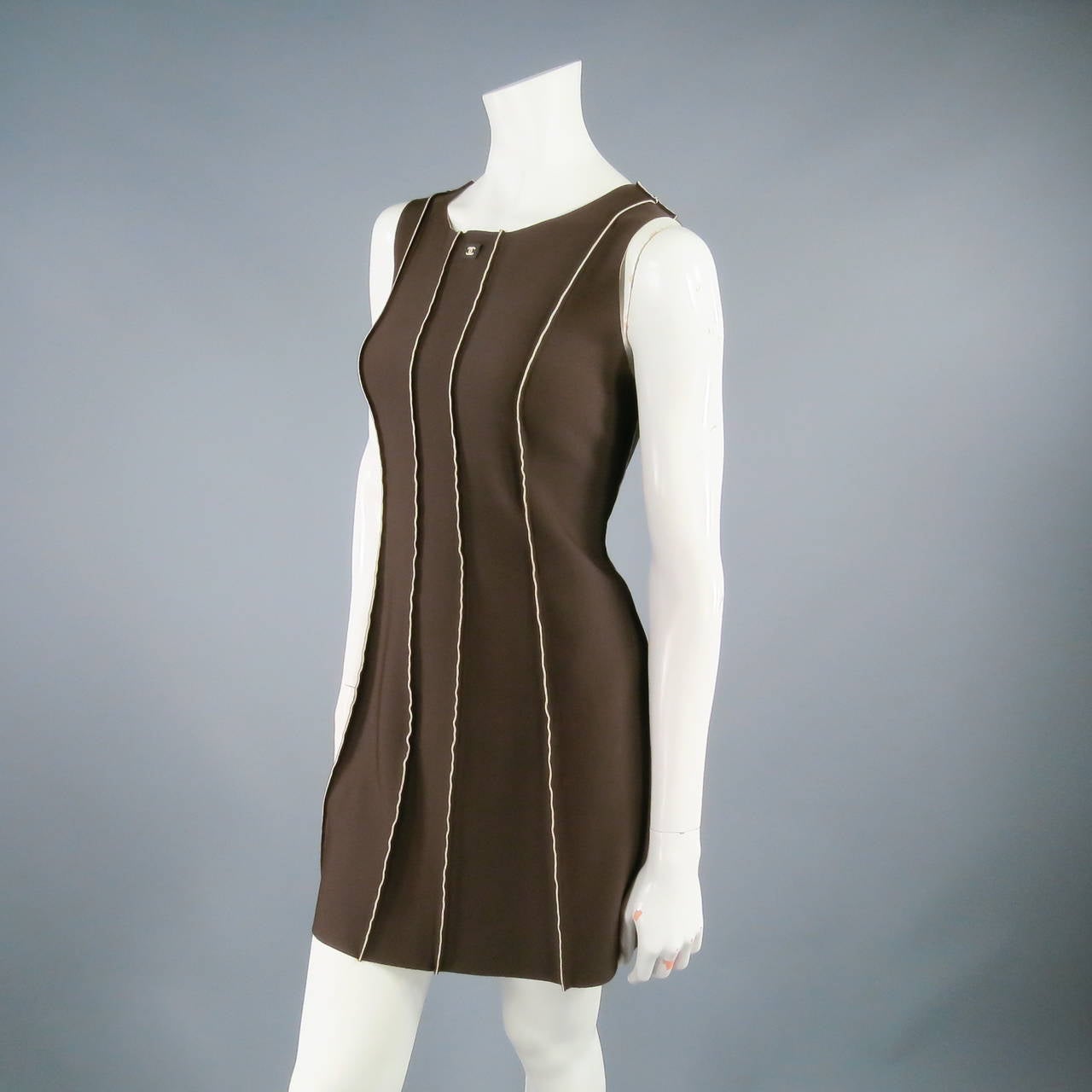 Fabulous scuba dress by CHANEL 1999P. A very unique find, this sleeveless A line style comes in a chocolate brown stretch neoprene and features exposed contrast lining along the seams and rubber 