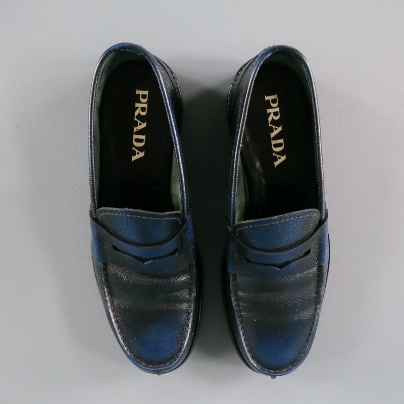 Classy PRADA slip on loafer in bison leather; pebbled texture in navy tone with a subtly distressed polish style.  Vertical front seam with horizontal back heel seam with tone on tone stitching. Comfortable suede interior.  Wooden stack toe with