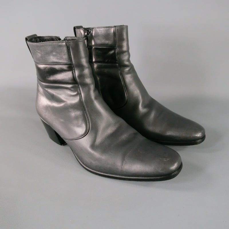 Simple, sophisticated charcoal leather ankle boot by DIOR HOMME.  Tapered to toe, wooden heel.  Pull tab loop at top back.  Interior side zipper for closure.  Wide horizontal stripe featured through body on both inside and outside.  Made in Italy.
