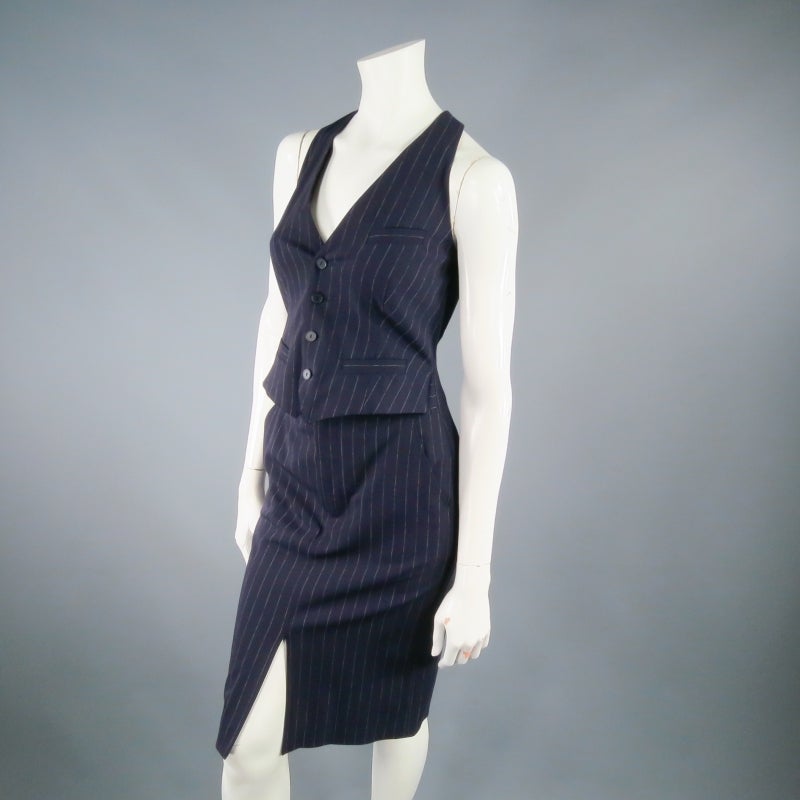 Fabulous menswear inspired cocktail dress by JEAN PAUL GAULTIER. This classic twist style features a connected halter vest and skirt in navy blue pinstripe and can be worn with the vest unbuttoned for a layered look. Lined in signature tattoo print.