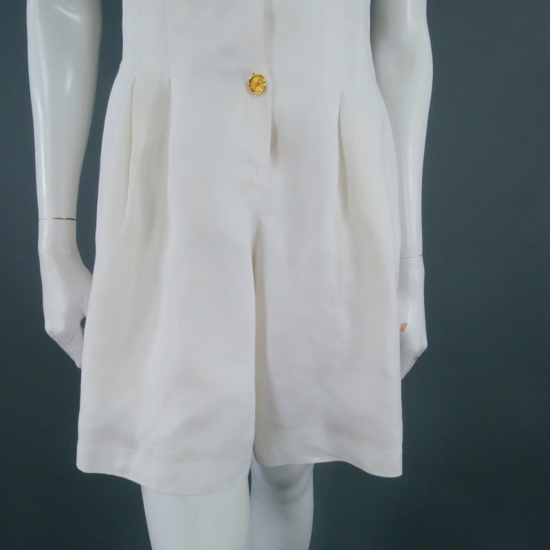 Fabulous vintage romper by HERMES. A classic chic piece perfect for summer in cream linen, featuring pleated shorts and gold pyramid stud buttons. Made in France.

Excellent Pre-Owned Condition.

Measurements:

Shoulder: 11 in.
Bust: 36