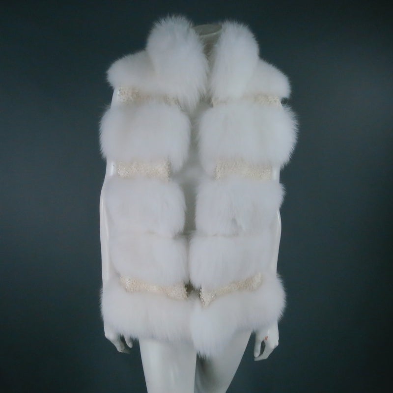 Stunning couture fox fur vest by Dennis Basso. A true show stopper, this gorgeous piece features soft snow white fur on the collar and bodice striped with panels of sparkling cream and crystal beads in between. A fabulous statement piece for an