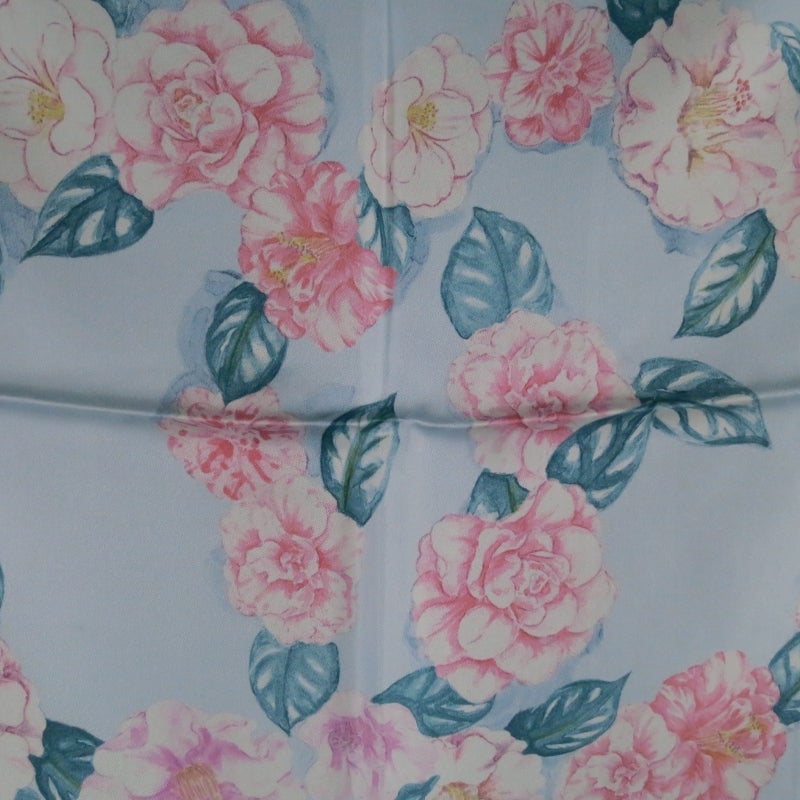 Chanel Pocket Square consists of a 100% silk material in a powder blue tone. 
Designed with a pink floral print seen throughout pocket square with leaf detail and pink piped boarder. Made in Italy.

Excellent Pre-Owned Condition