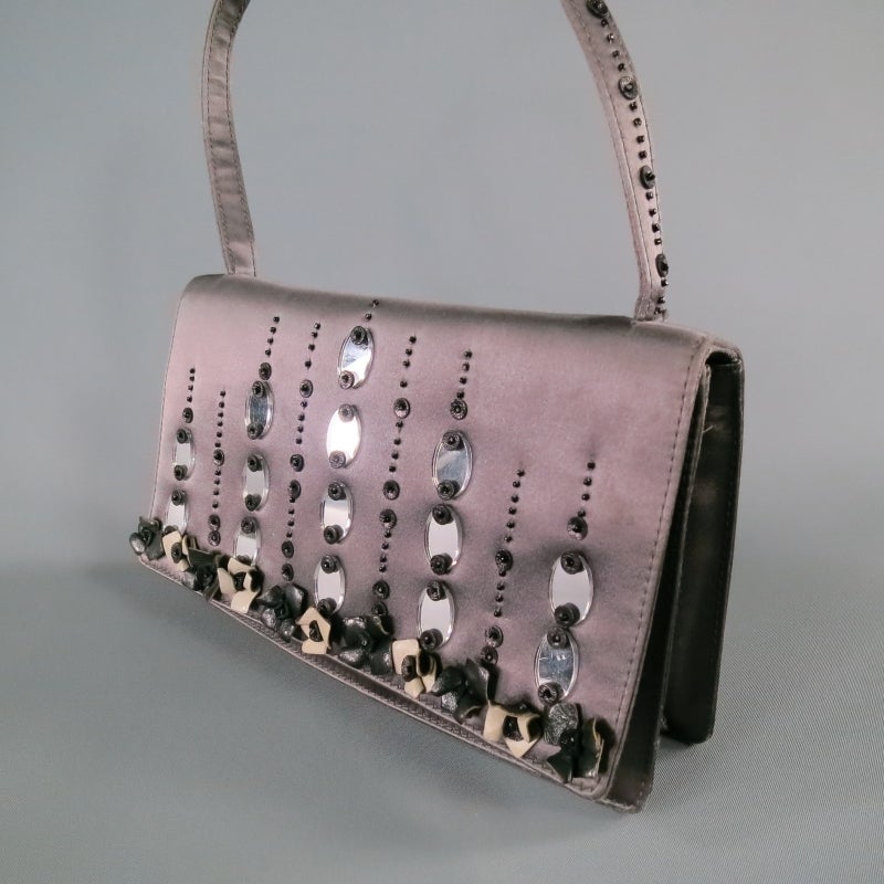 Gorgeous charcoal silk purse by PRADA. In a classic rectangular box shape, featuring symmetrical embellishments of beads, mirrors, and gray and black leather flowers. A very unique piece with a lot of work put into it. Made in Italy.
 
Excellent